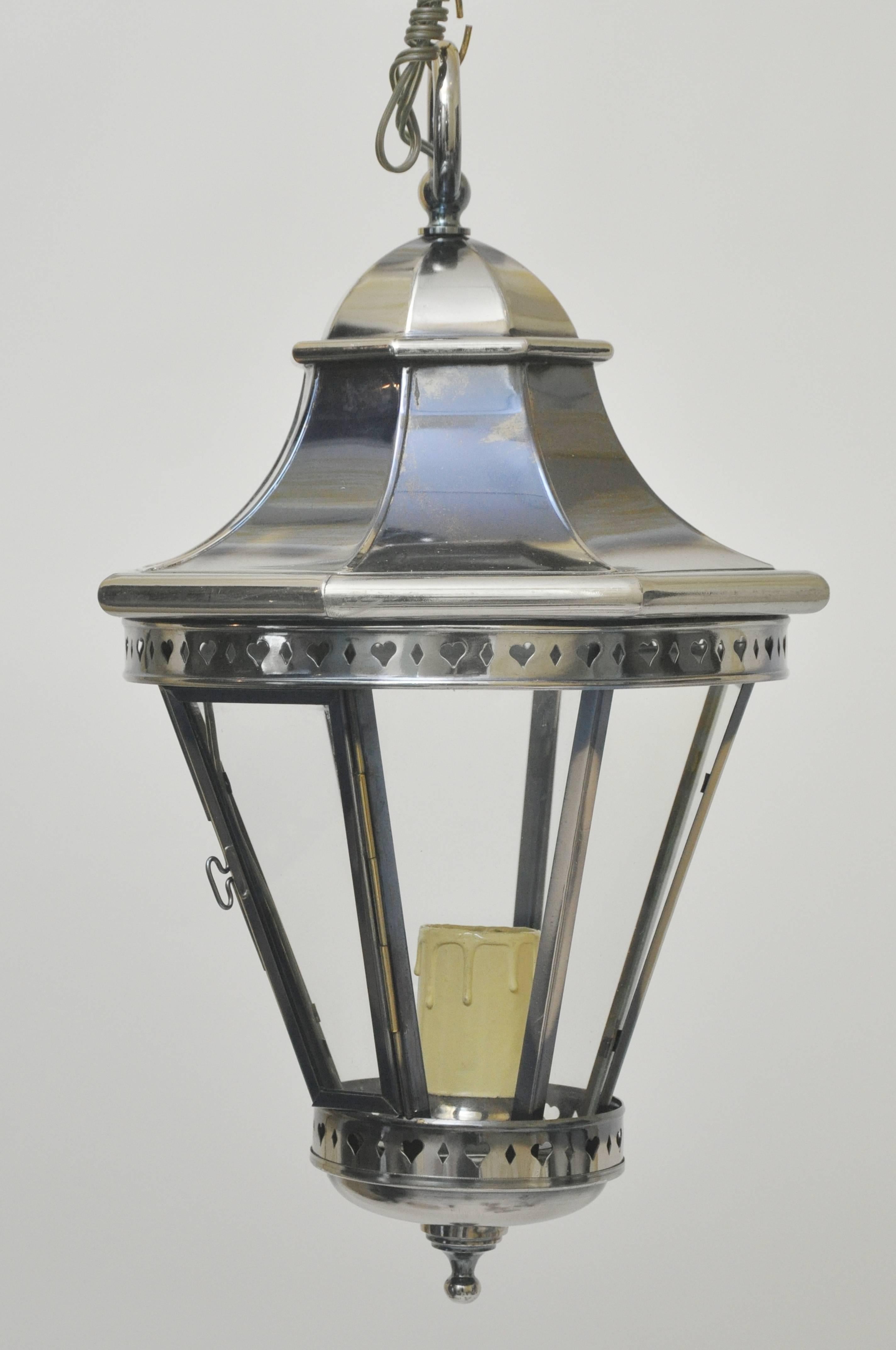 Vintage 1970s nickel lanterns from Spain. Never used. Octagonal shaped with one panel a hinged door to replace the bulb. Standard based light bulb required up to 75 watts. Beautifully made. Dimensions listed do not include 12 inches of chain and