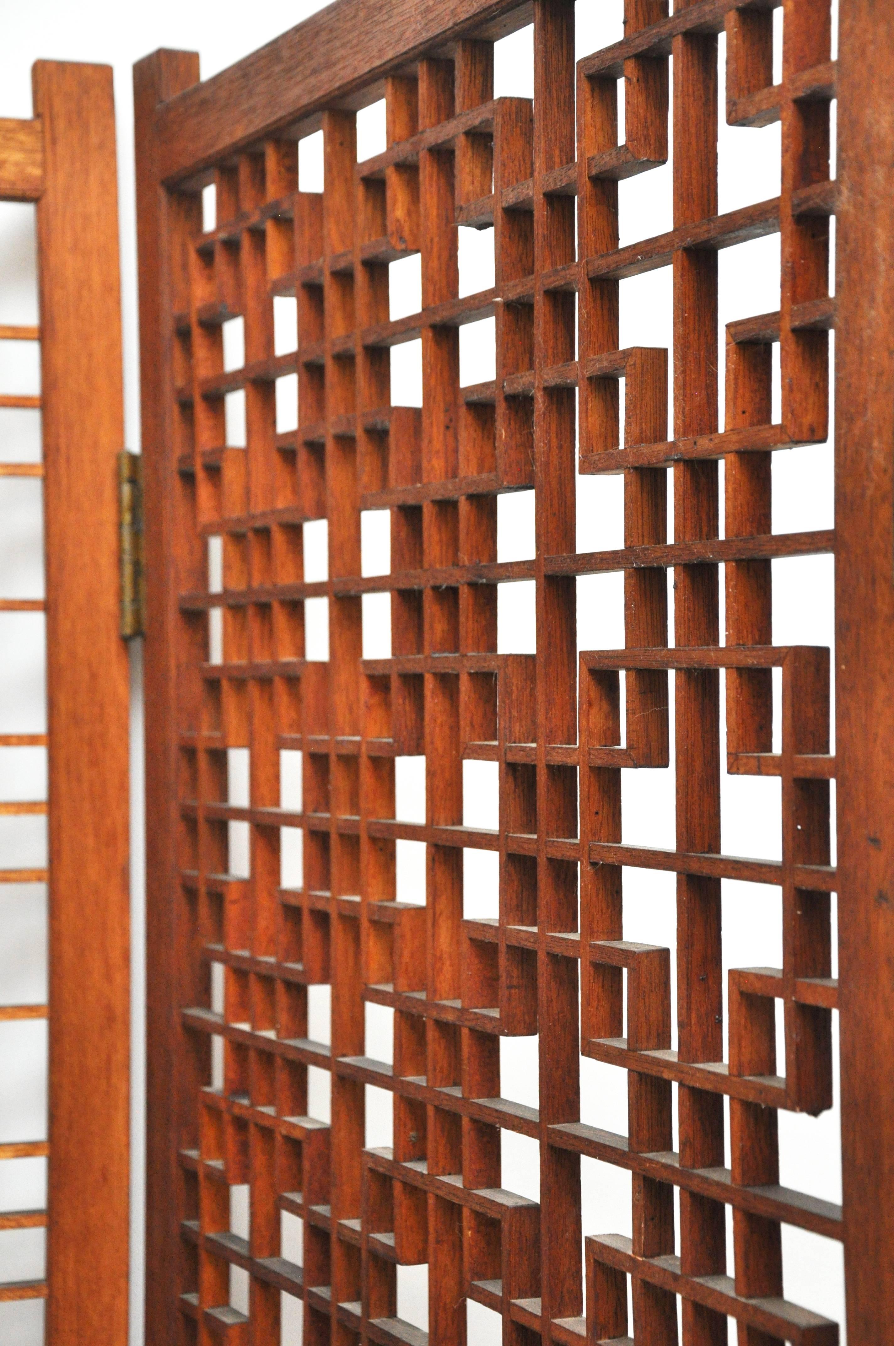 Very large four-panel room dividing screen with intricate design. Screen is formed from teak. The intricate geometric pattern is created simply through masterful craftsmanship, with the placement of each piece of delicately cut teak. No missing or