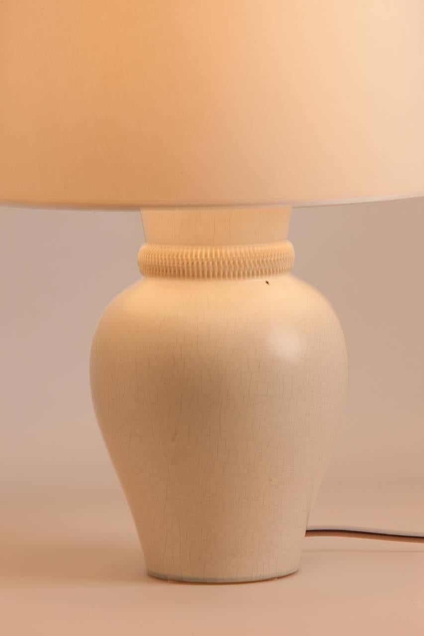 French ceramic table lamp attributed to Chambost. Lamp features white crackle glaze and custom silk shade made in Paris.