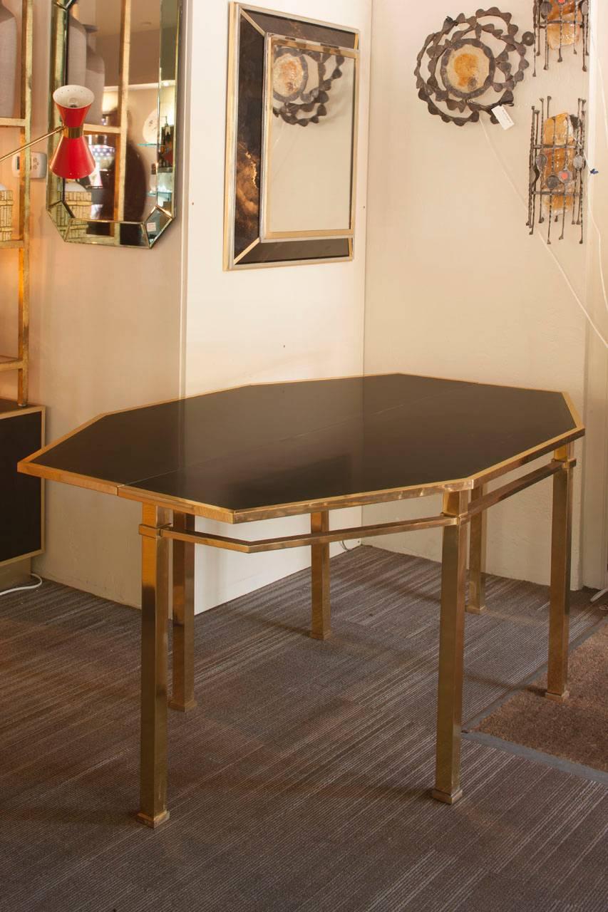 Pristine console and mirror duo by Guy Lefevre for Maison Janson. The console has a mechanism which allows the top to unfold creating a dining table for 6. Both the mirror and console are in excellent condition.