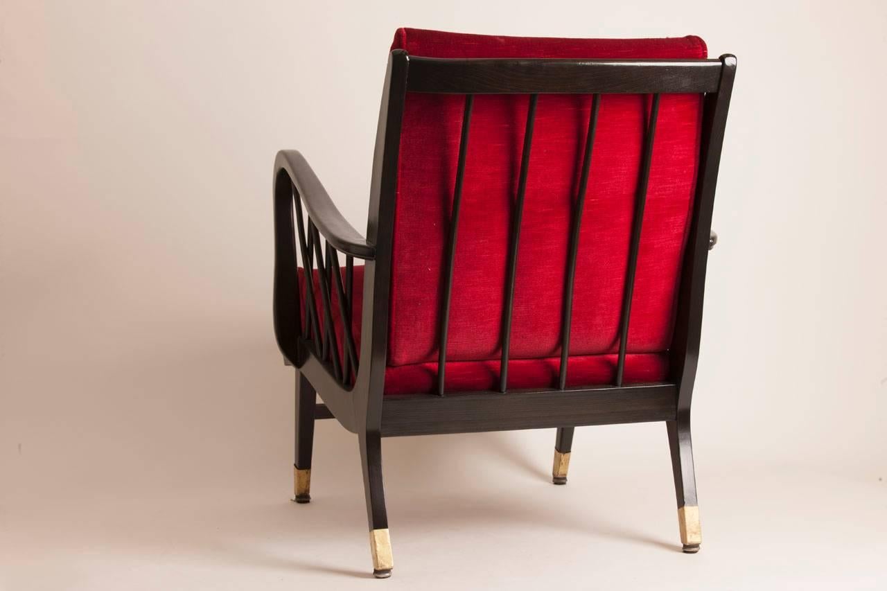 Pair of French Mid-Century armchairs in ebonized oak with brass detailing to the feet. The upholstery is original but the frames of the chairs have been completely restored.