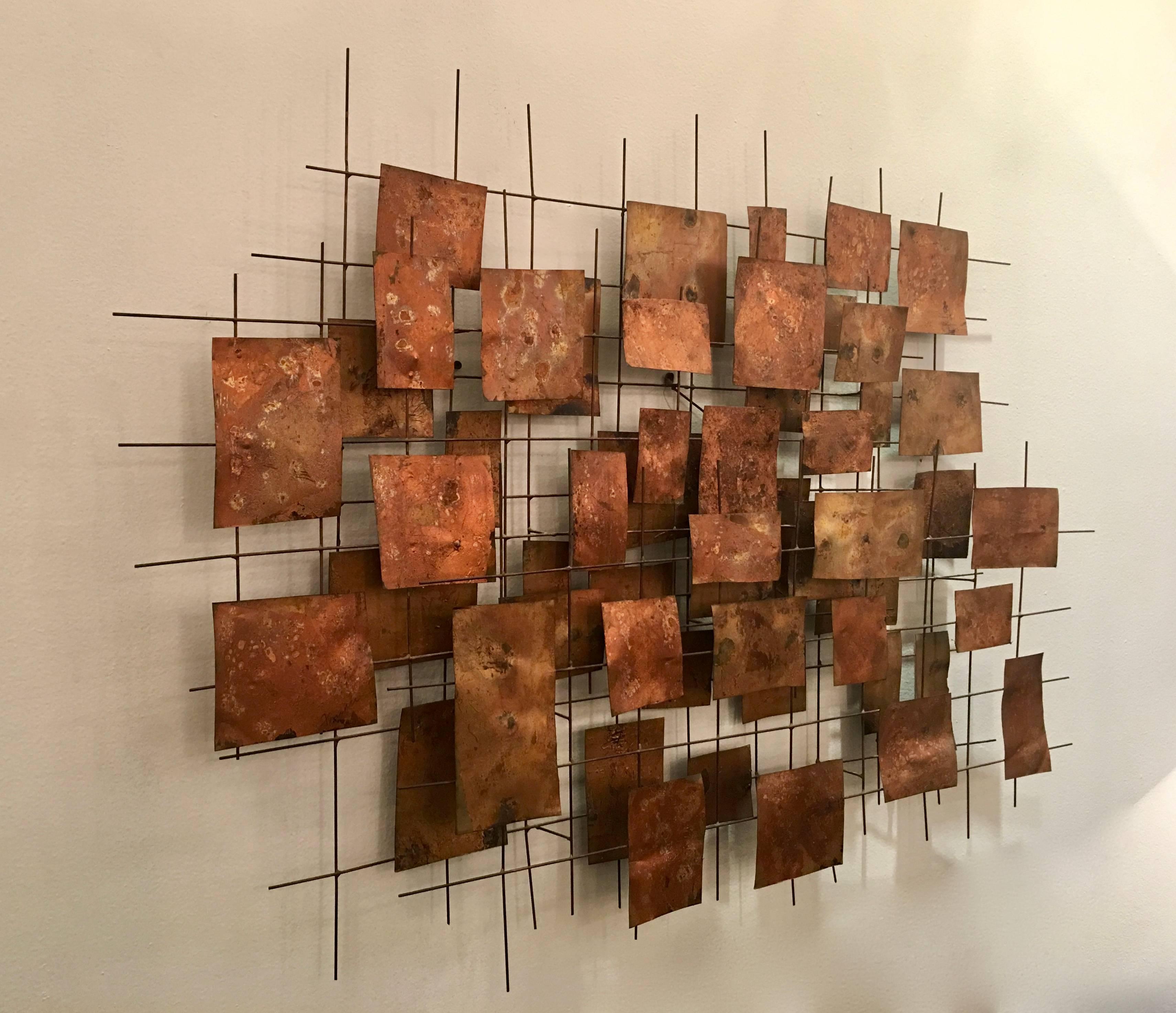 Remarkable modernist wall sculpture by artist William Friedle. The piece has mixed metal platelets that are artistically patinated with a gold leaf finish ​and arranged on an architectural grid. Please contact us for location.