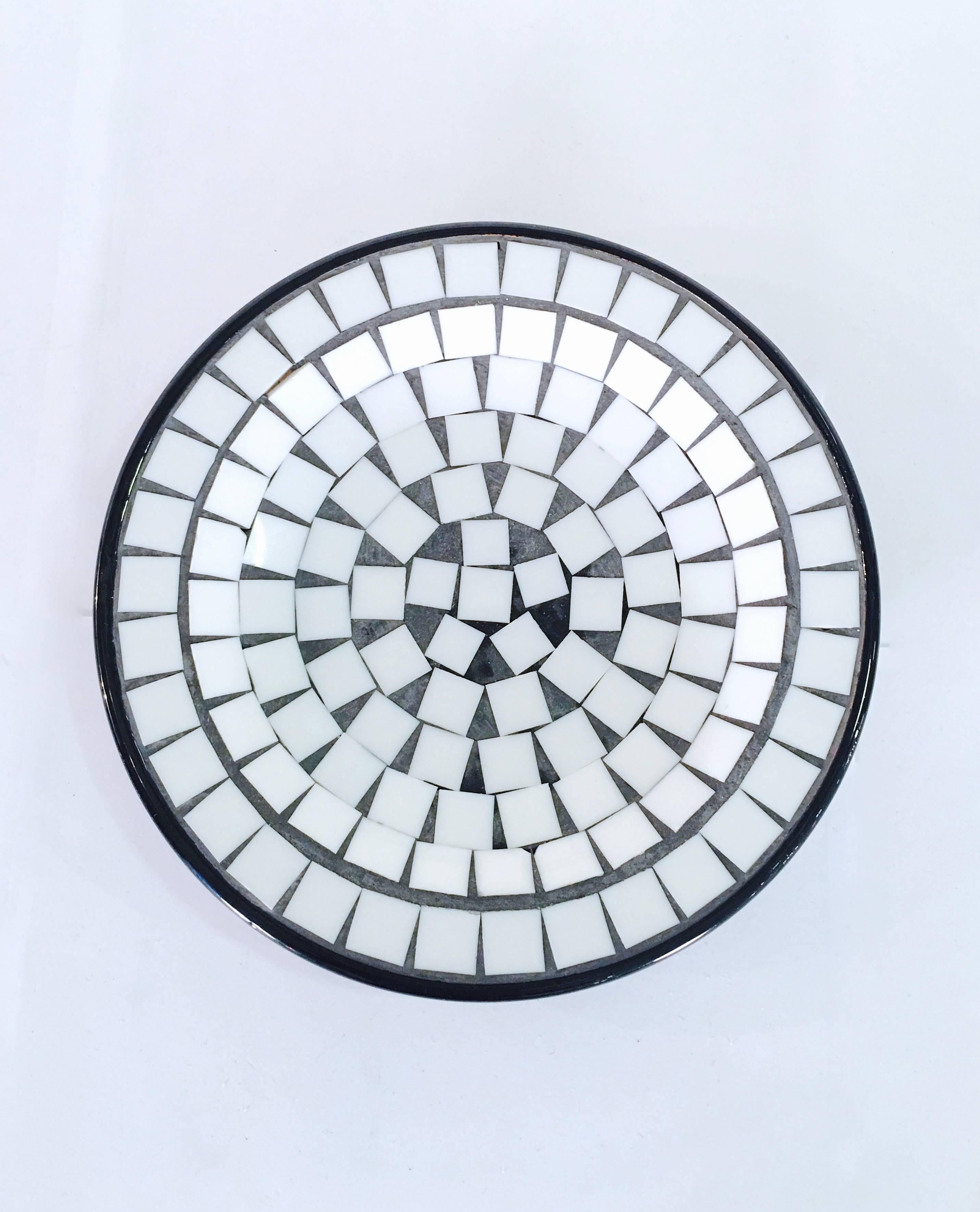 Nicely done decorative pottery plate with an inlay of white tiles. The piece is finished in a black glaze. Please contact for location. Offered by Las Venus by Kenneth Clark, New York City.