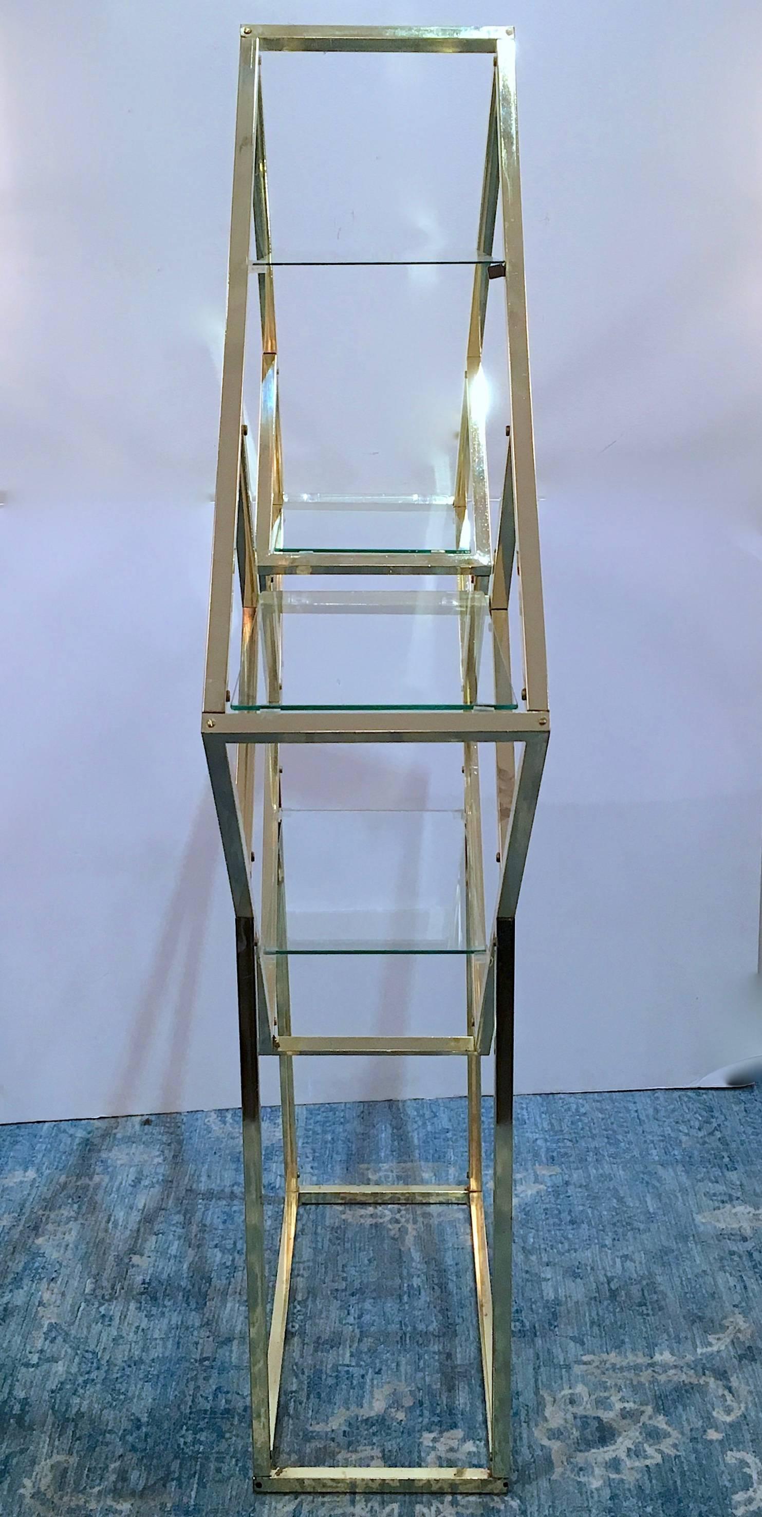 Diamond shaped étagère on a stand finished in polished brass. Please contact for location. 
