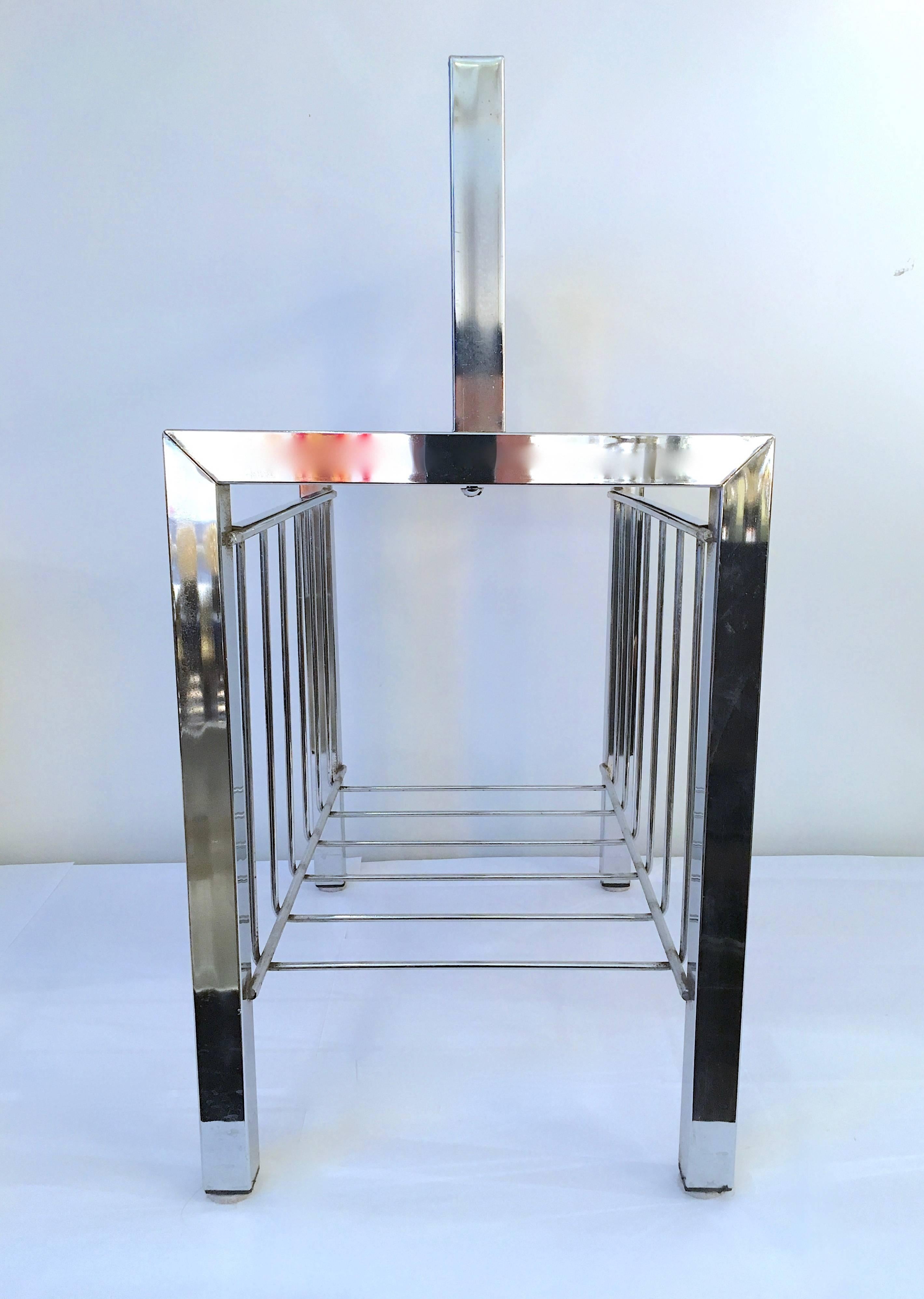 Crisply designed modernist magazine rack finished in polished chrome. Please contact for location. 