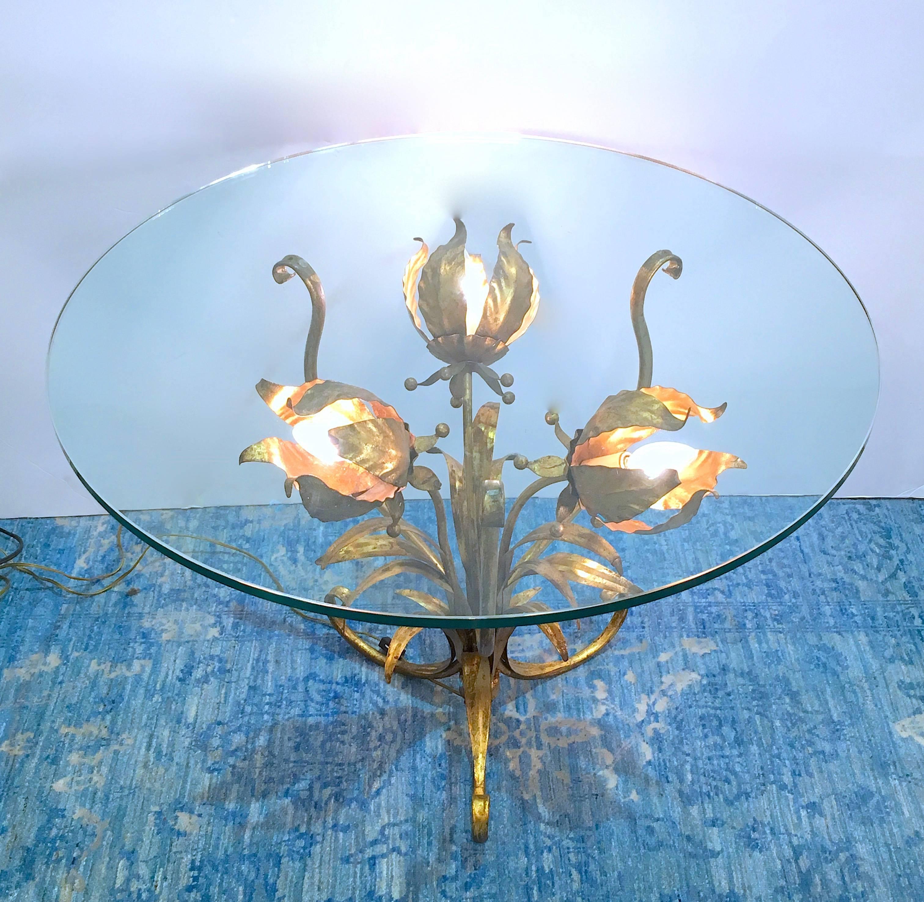 Side or end table with a sculptural gilt tole base with three flowers. Each flower is illuminated and the effect is lovely. Please contact for location. 