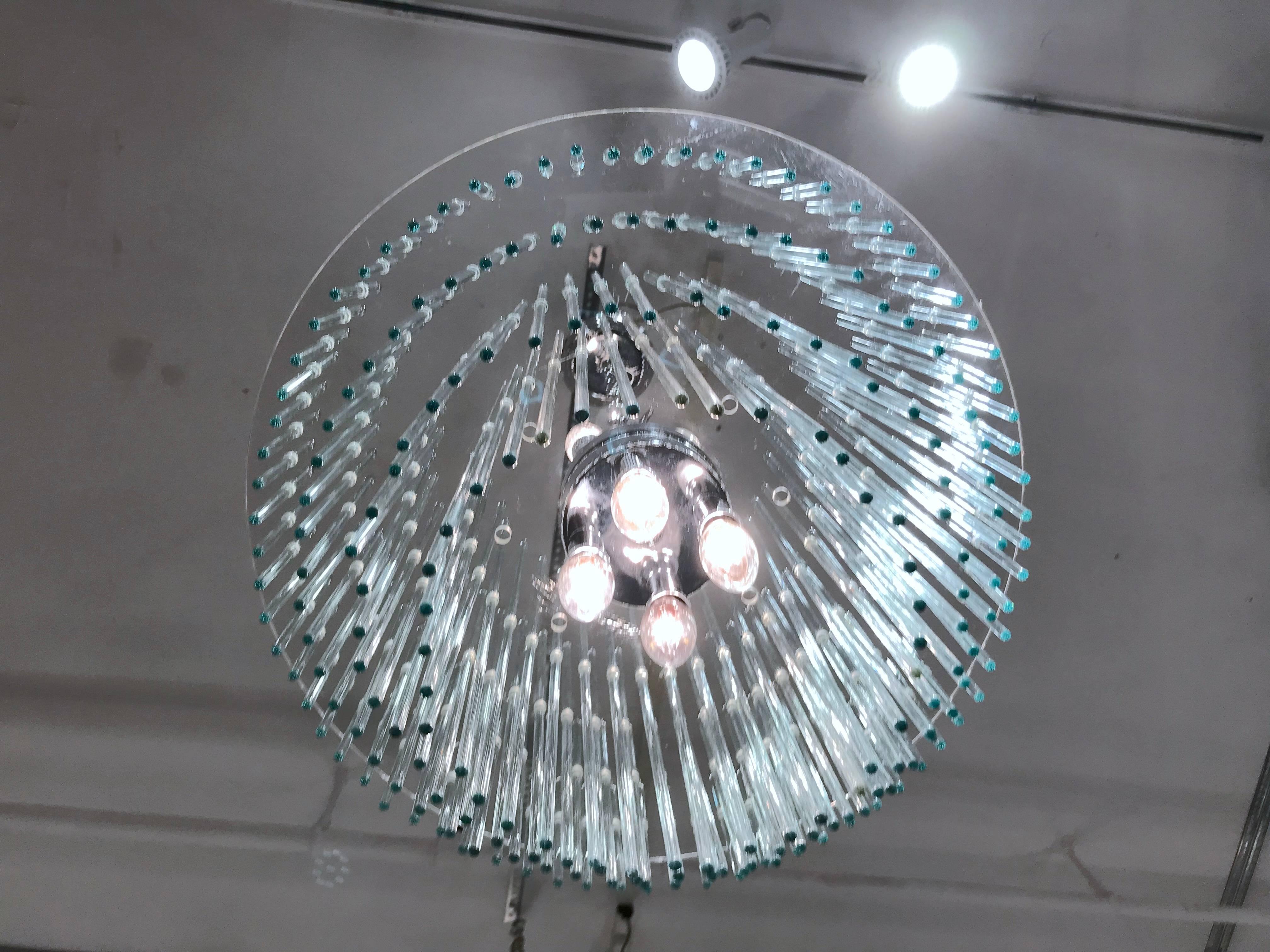 Wonderful chandelier with a Lucite armature and crystal rods that are arranged in several tiers. The light sockets are finished in polished chrome. Please contact for location. 