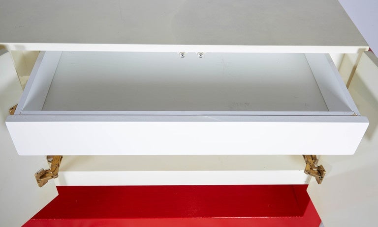 Stunning faux parchment credenza suspended with Lucite joints on a lacquered grass cloth support base finished in a bold red. The piece is illuminated from below, which creates a lovely glow. Beautiful! Please contact for location.