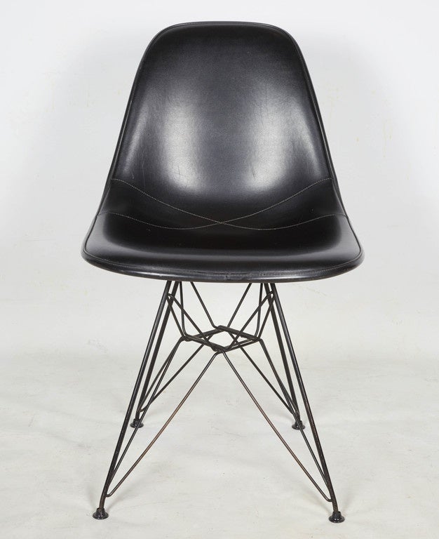 A classic and handsome statement in black: Eames upholstered side chair with eiffel tower base. Please contact for location.