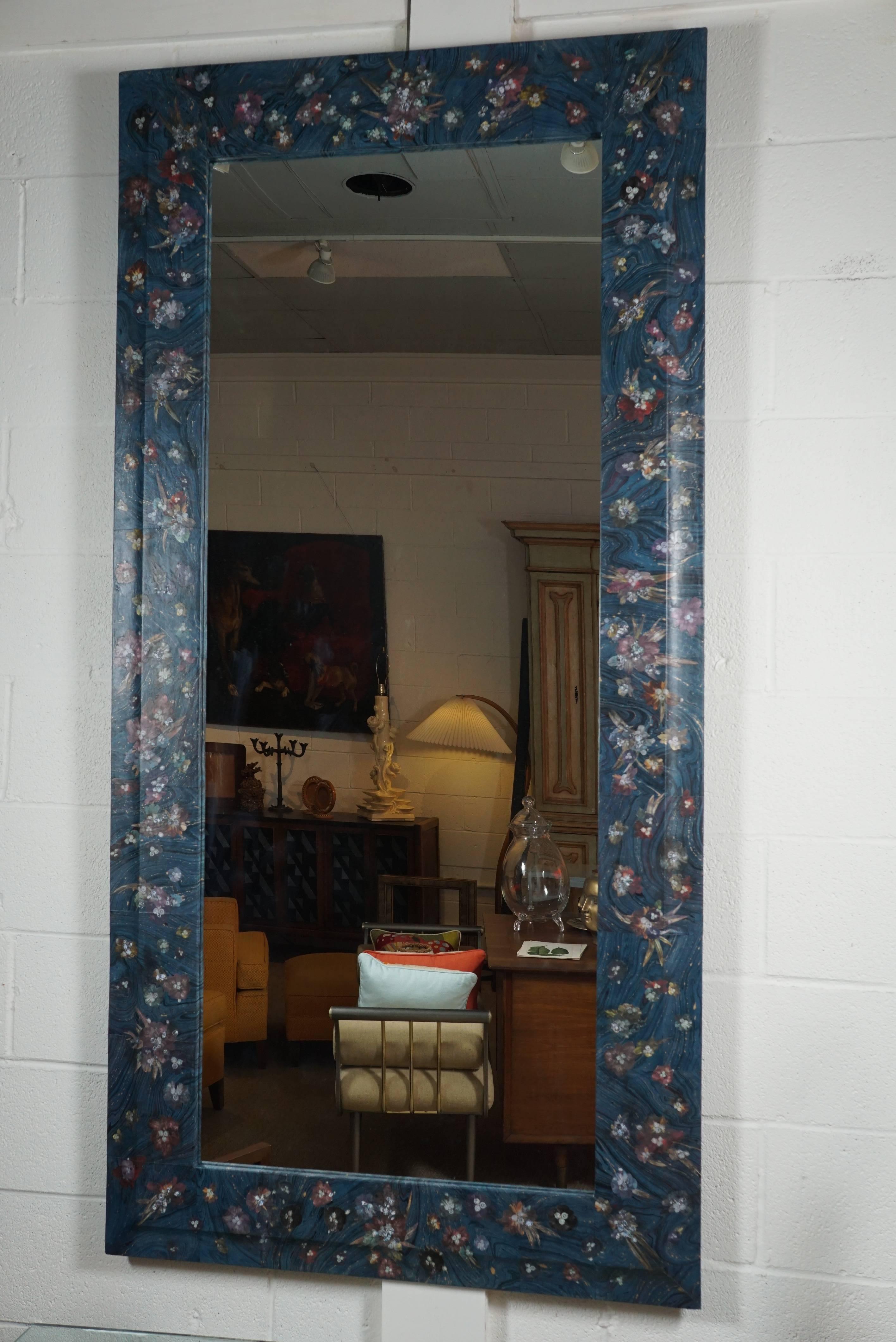 Here is a beautiful and unique full length decoupage mirror in a blue marbleized paper with floating images of flowers and diamonds and palm fronds. The flowers are images of glass and diamond jewelry. The intricately cut images are superimposed to