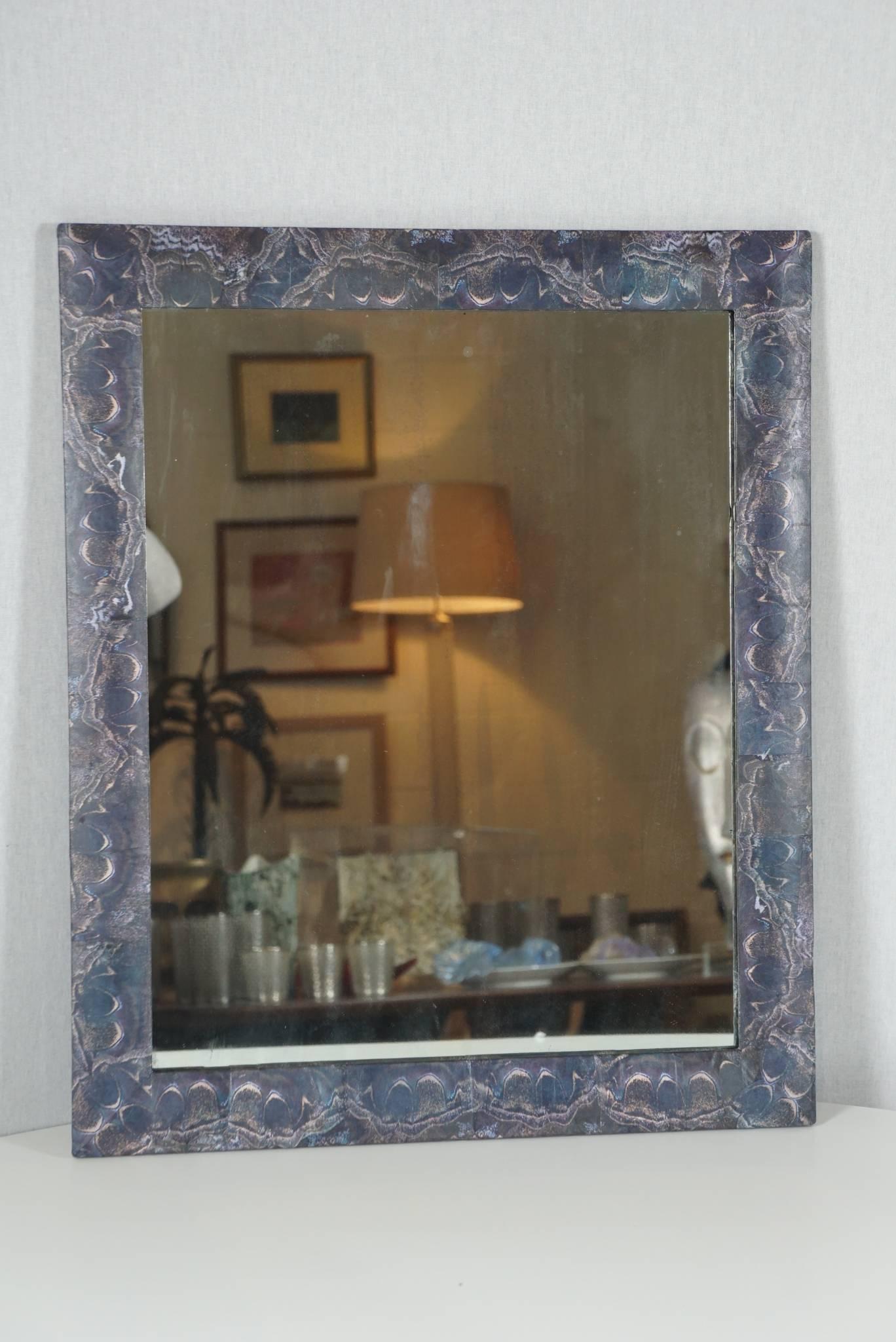 Here is a unique and petit decoupage mirror in a moth wing block pattern. The images are printed paper. The surface has been treated with a clear coat finish for the desired patina and a sealed finish. The original mirror and wood frame is vintage.