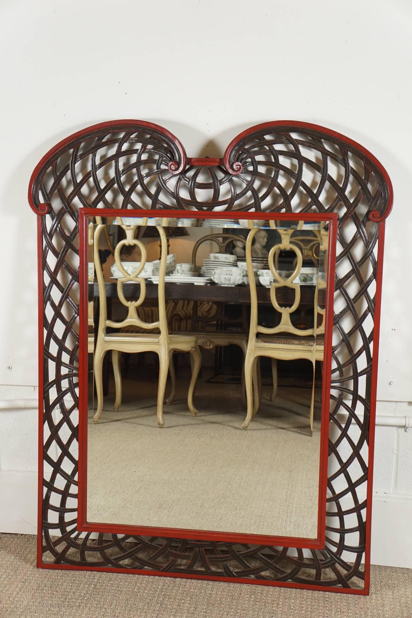 Here is a great Hollywood Regency style mirror with a curvilinear lattice border. The frame is cast in resin with a high lacquered surface. The mirror insert is beveled and measures 31.5 inches high and 23.5 inches wide.