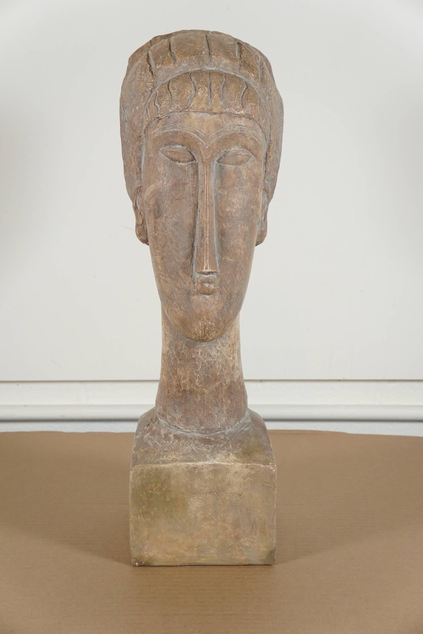 Here is a great ceramic bust in the style of a Modigliani stone sculpture.
The sculpture is both modern and primitive in it's style.