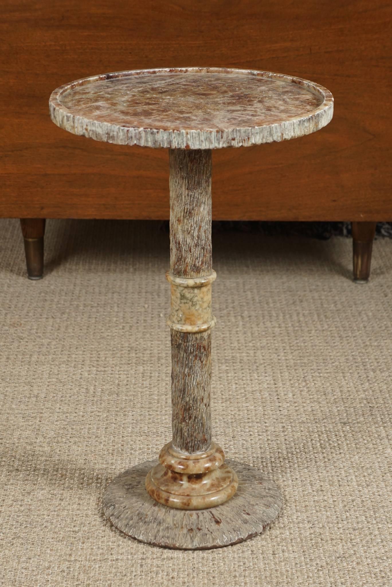 Here is a beautiful marble drinks table with an intricately carved faux bois design.