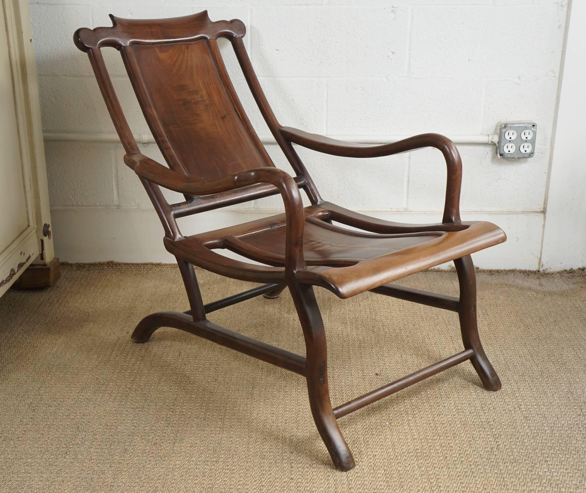 Here is a gorgeous and sculptural Chinese plantation chair in a rich walnut 