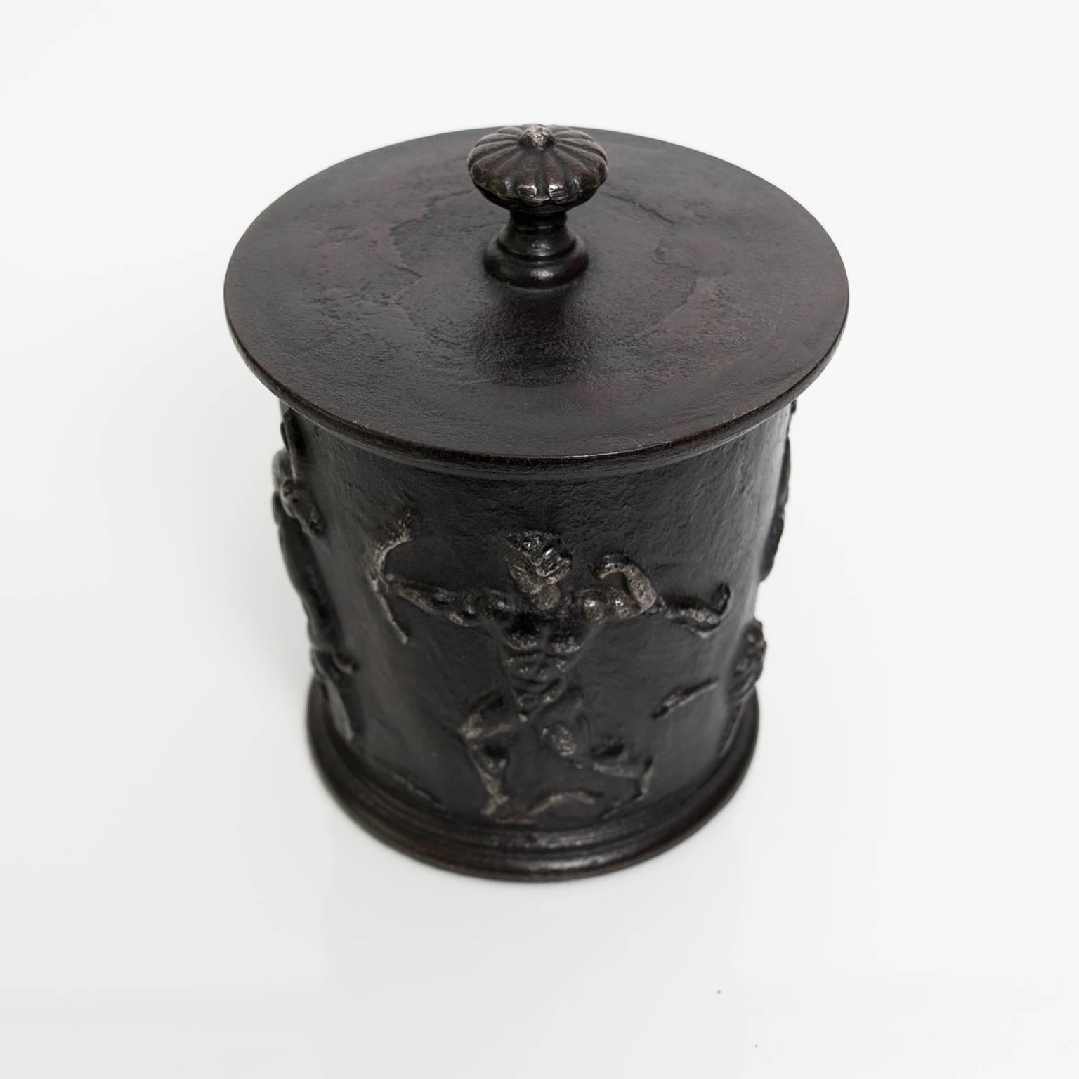 Scandinavian Modern, Swedish Grace cast iron tobacco jar with lid. The exterior is decorated with a male and female figure, a stag, a doe and a bird. Designed by Carl Elmberg for famed ironworks company Näfveqvarns Bruk. Total height 7
