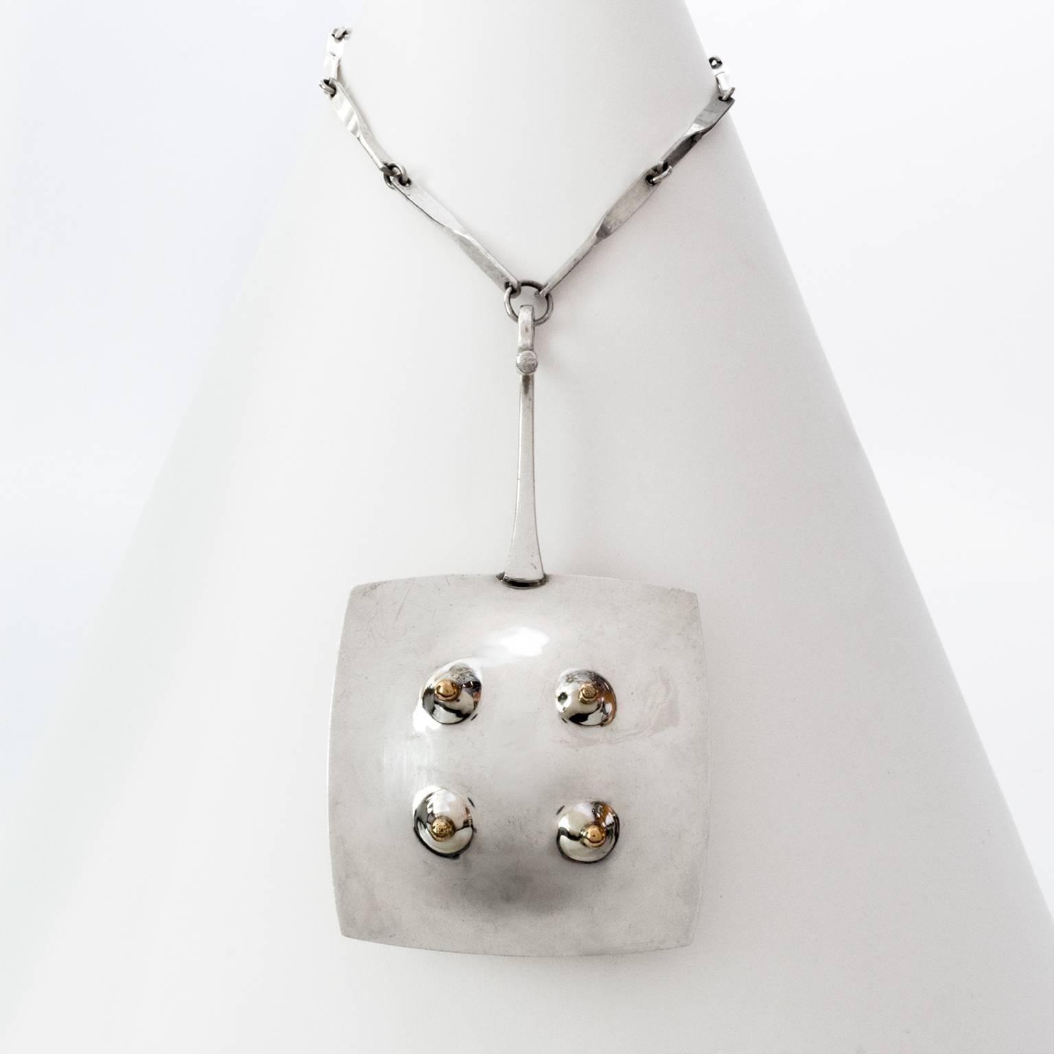 Scandinavian modern sterling silver pendant with gold details, inspired by the early 20th century Surrealism art movement. Made by One Bohlin, Stockholm, Sweden, 1972, with details in gold, original chain. Designed by Ove Bohlin.

Pendant length: