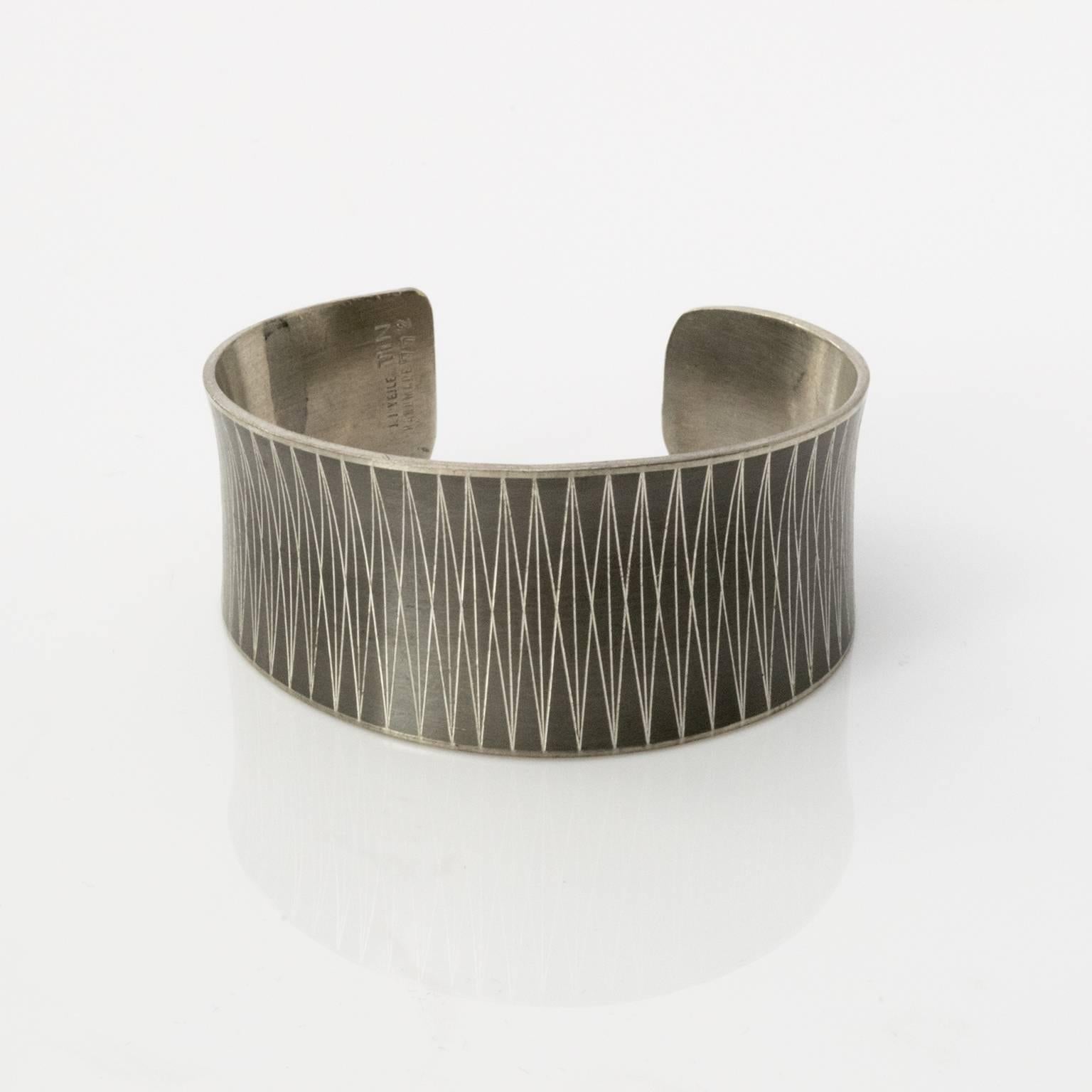 Patinated pewter bracelet with engraved geometric pattern. Designed by Jørgen Jensen, Vejle, Denmark, 1950s.
Diameter:2.75.
Height: 1.5`