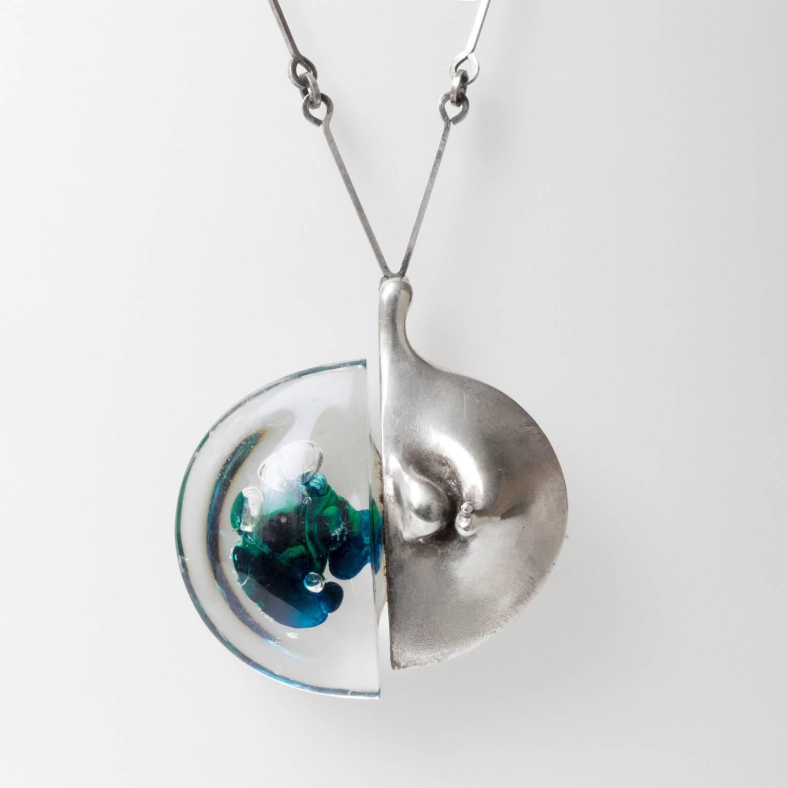 Scandinavian Modern Bjorn Weckstrom "Kilimanjaro" necklace and pendant in silver and acrylic. Made at Lapponia, Finland, 1970s.
Width 2.5".
Pendant height: 2.75".
Chain height: 26".