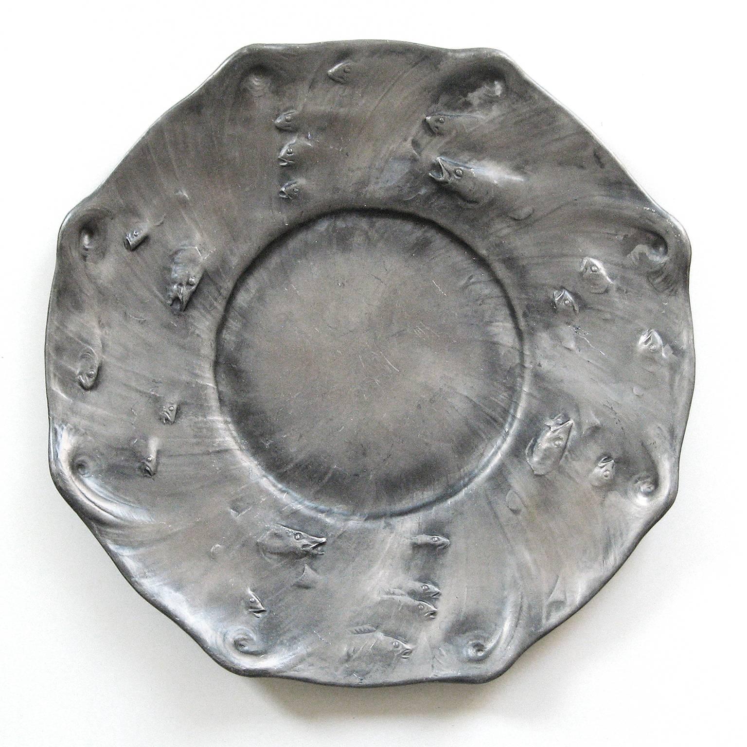 Swedish Art Nouveau pewter charger with fish and wave in relief. This is a rare early example from 1904 and is signed and dated on the reverse. Designed by noted sculpture Olof Ahlberg and made by Schreuder & Olsson, Stockholm, Sweden. Measures: