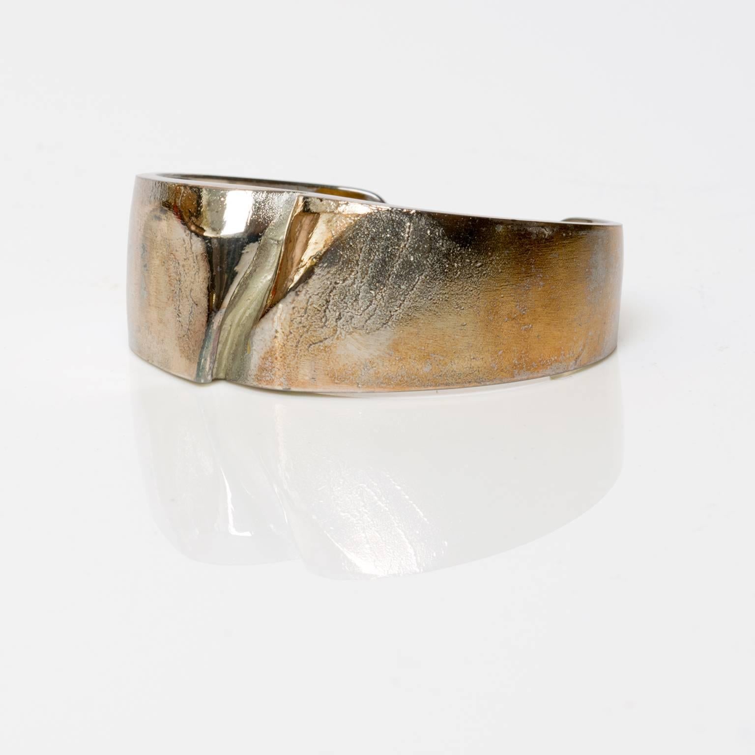 A Scandinavian Modern Finish silver bracelet in silver by Bjorn Weckstrom for Lapponia, 1971. Weckstrom's work is famous for his unique patination treatments and surface textures.
Measures: Width 2.5".
Depth 2".
Height 1".