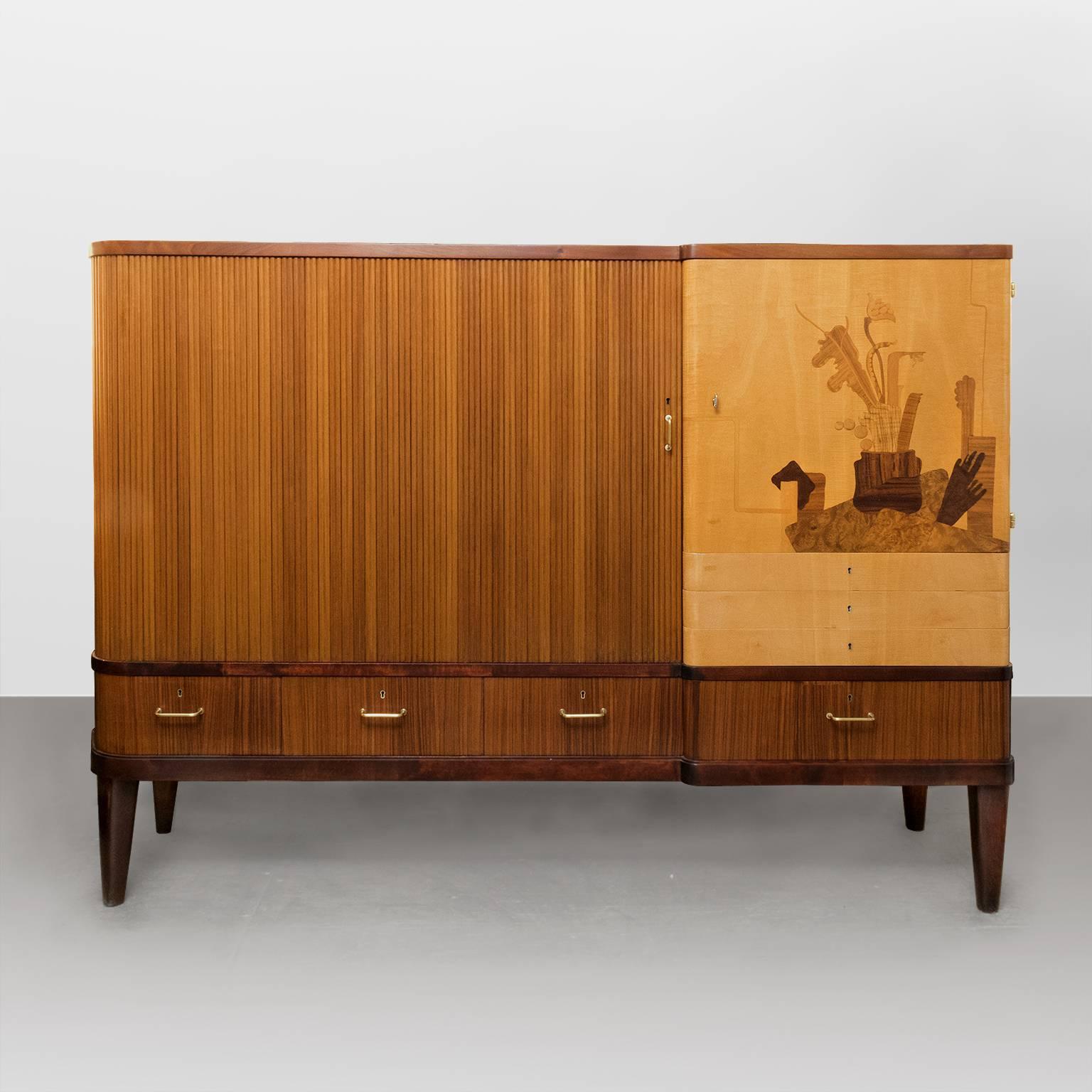 A beautiful Scandinavian Modern cabinet by artists and designer Erik Chambert. The cabinet has a sliding tambour door covering a large space with two adjustable shelves. One door features an abstracted marquetry still life by Chambert made from a