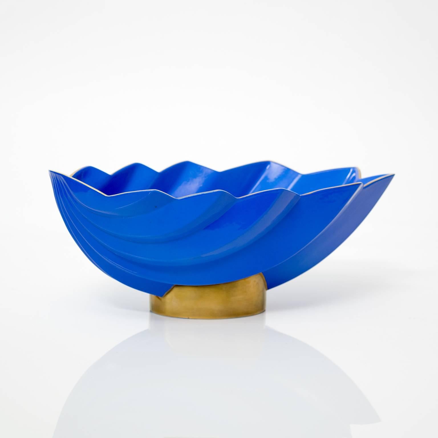 A large elegant Scandinavian Modern cobalt blue colored glaze ceramic footed bowl with gold details. Designed by Karin Bjornquist for Rörstrand, Sweden, signed and dated 1993 on the bottom length.