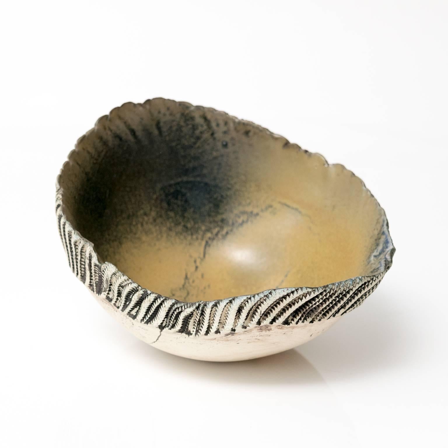 A unique Scandinavian Modern hand built and glazed bowl by artist Bengt Berglund for Gustavsberg Studio, 1960-1977. The exterior of the bowl is partially glazed, the interior glazed in blue-greens.
 
Measures: Diameter 7.25, height: