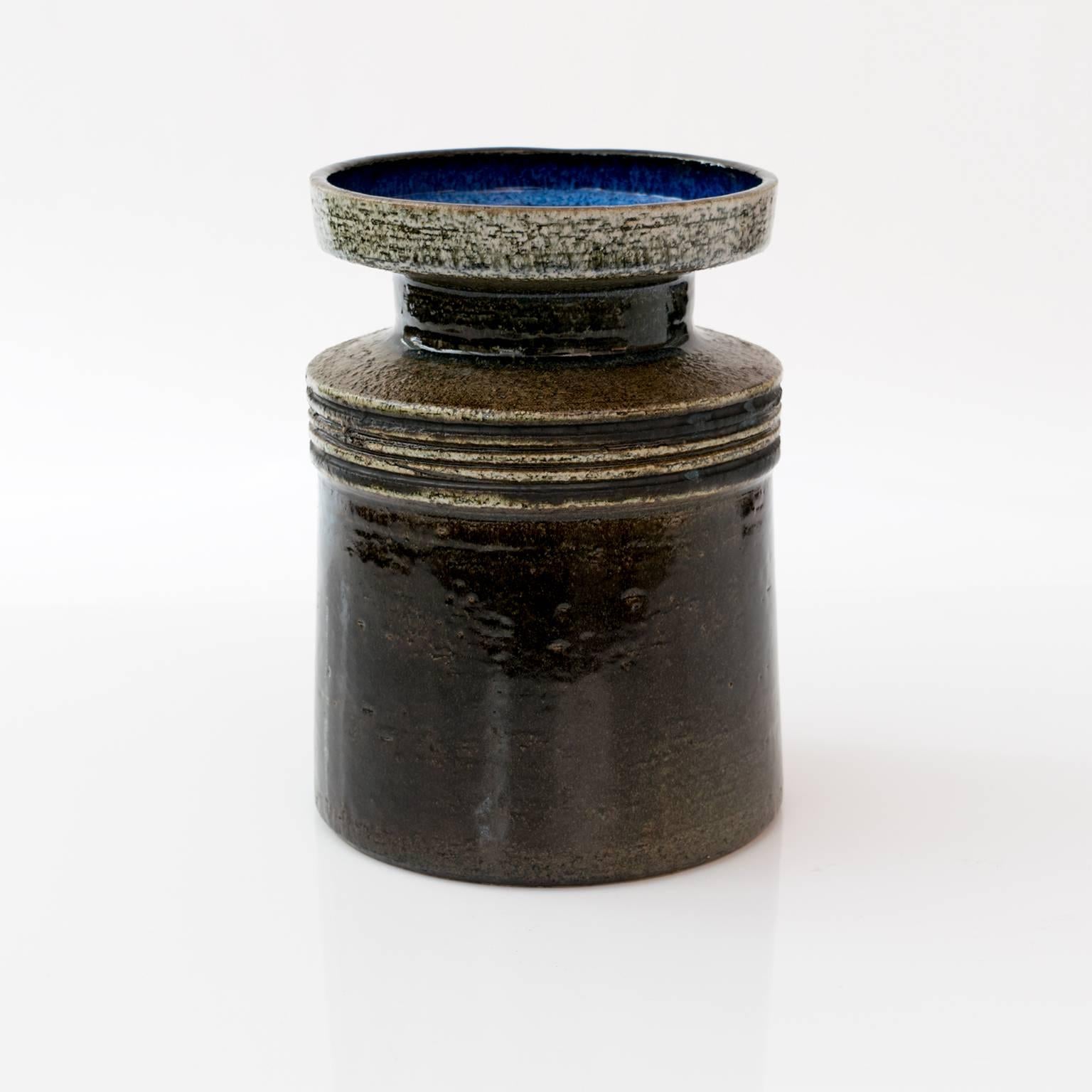 A Scandinavian modern vase by Britt-Louise Sundell for Gustavsberg, circa 1960. The vase has deep glaze over a textured surface and a shiny blue glaze inside.
 
Measures: Height 9