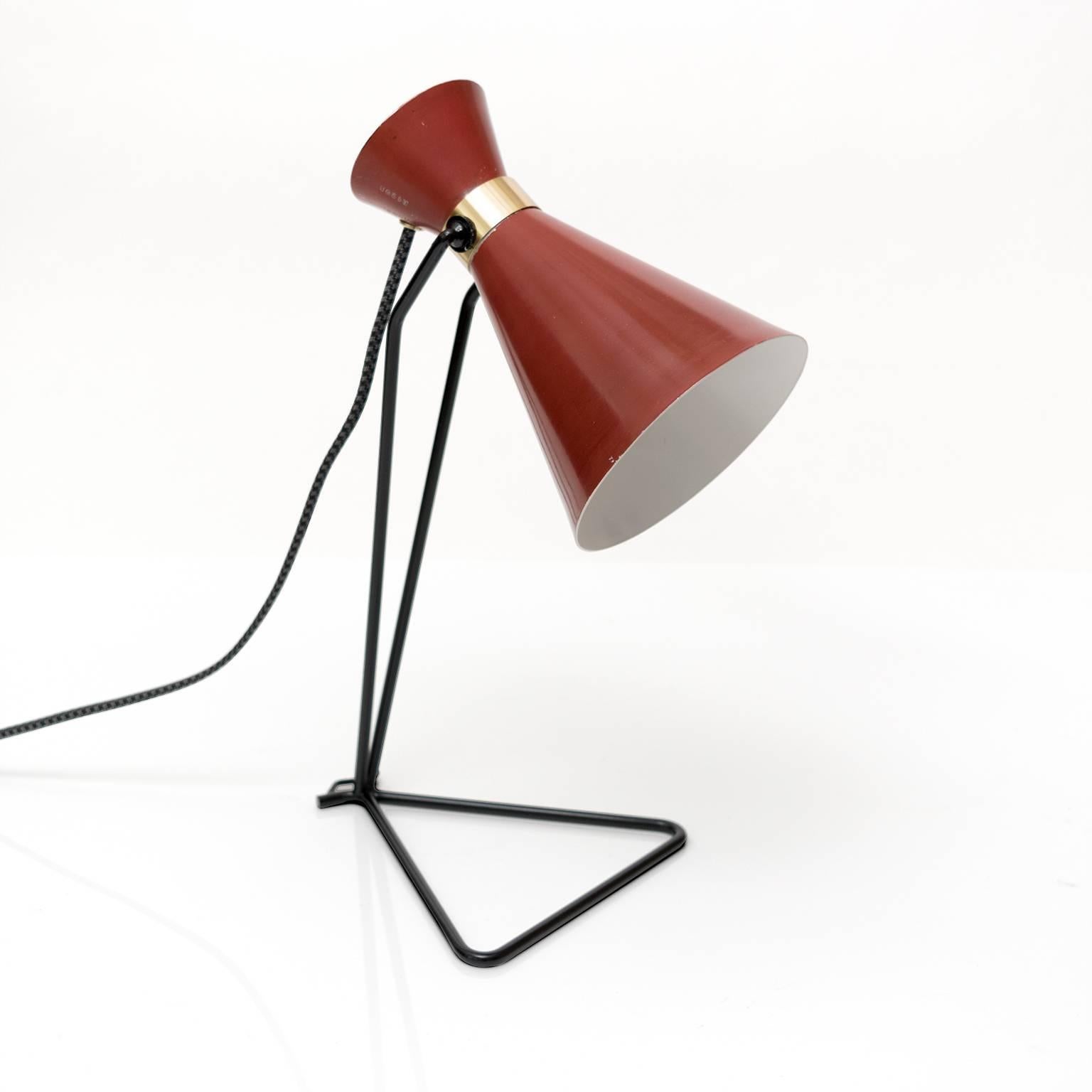 A Scandinavian Modern desk lamp by Svend Aage Holm Sorensen for the lighting company ASEA. The lamp retains ifs original red paint on the adjustable shade which is detailed with a newly polished and lacquered brass band. Newly electrified with one
