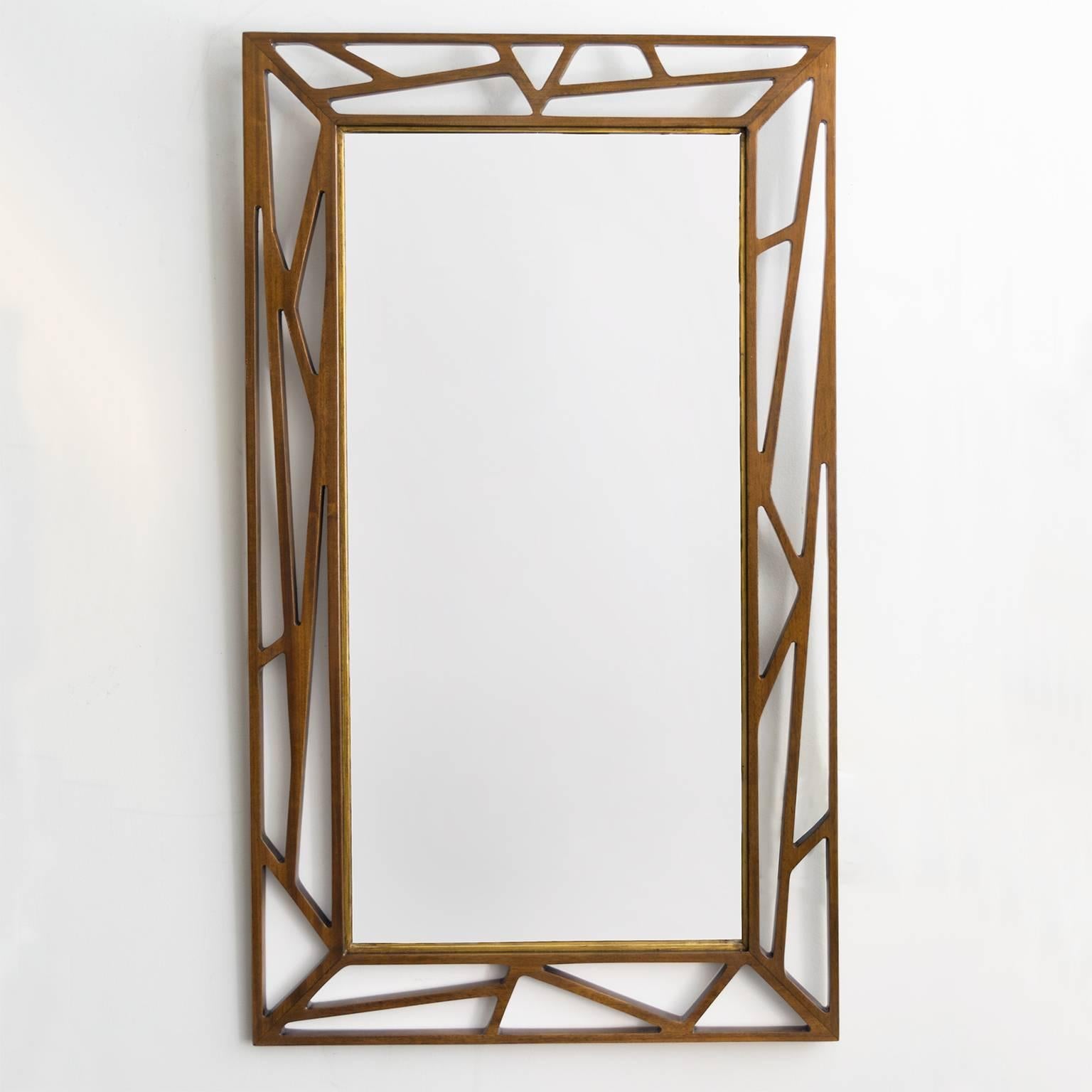 Scandinavian modern teak mirror detailed with gold from Gustaf Eden Spegalfabrik, Sweden. Each side of the mirror's frame has a different design. Newly restored, stained teak wood. Measures: Height 41.5