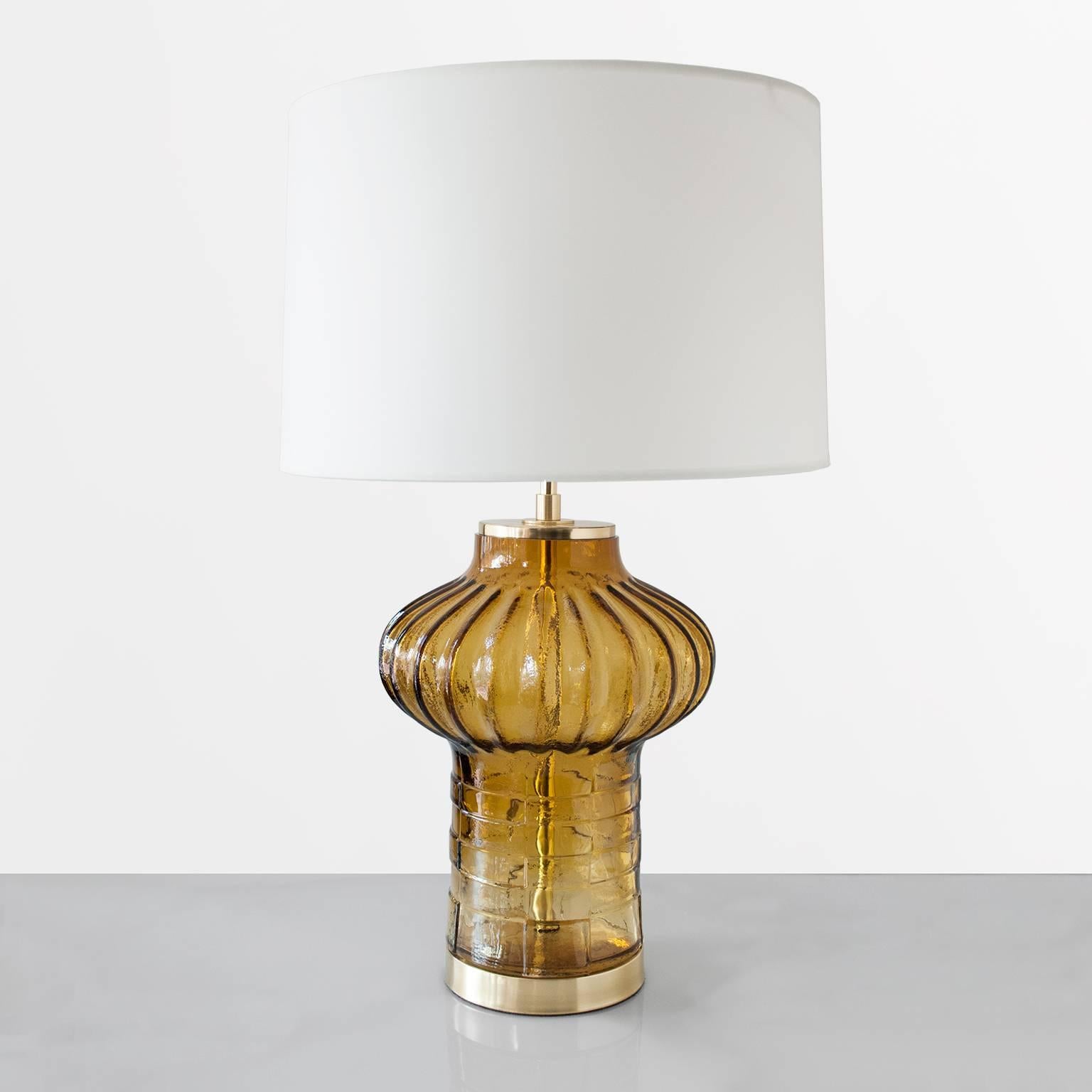 Mid-century lamp with a large studio art vase by Christer Sjogren in amber colored glass. Fitted with polished and lacquered brass foot and cap, with newly wired double socket clusters. Produced at the Lindshammar workshop in Smaland, Sweden.