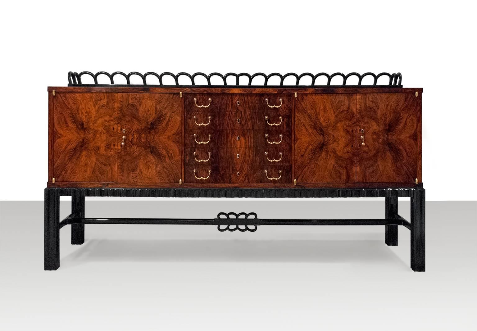 Beautiful Art Deco rosewood sideboard cabinet by Jindrich Halabala produced while head of UP (United Woodcrafts Manufacturers company) in Brno. The cabinet has book matched rosewood veneer on its drawers, doors, top and sides. Drawer and door pulls