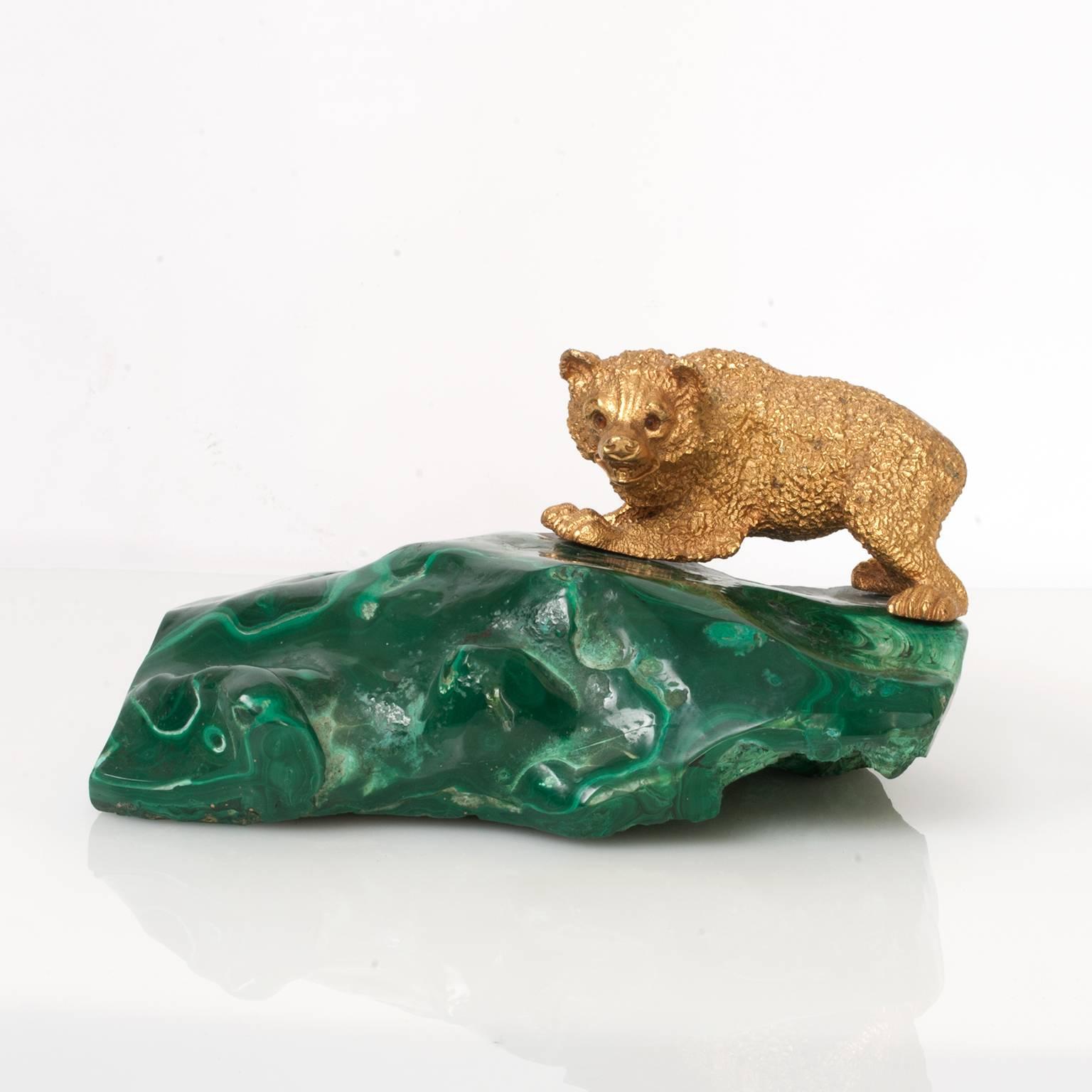 Russian gilded bronze bear cub sculpture on a sold piece of Malachite in the form of a landscape. The bear's eyes have golden glass or stones. Measures: Length: 9.5