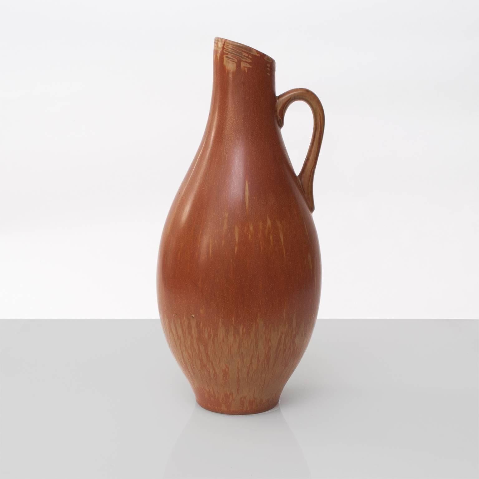 A large Scandinavian modern ceramic pitcher vase with hare's fur glaze. Designed by Gunnar Nylund for Rorstrand circa 1950.
Height: 14.25