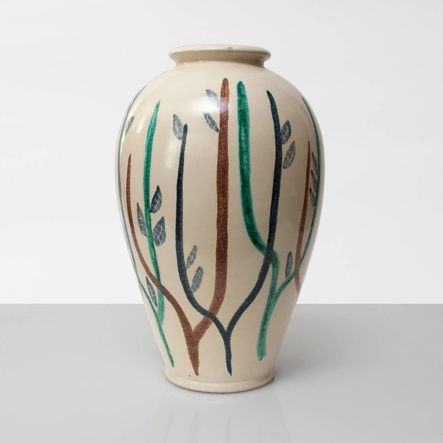 A large Scandinavian Modern ceramic vase in a cream colored glaze and hand decorated by designer Mette Doller. Produced at Höganas Keramik, Sweden circa 1950. 
H: 16