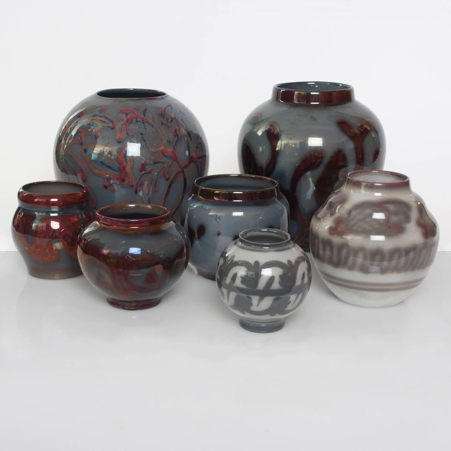 Group of 7 Art Deco luster glazed ceramic vases by Edgar Bockman for Hoganas Keramik, Sweden. 
Heights:  8.25