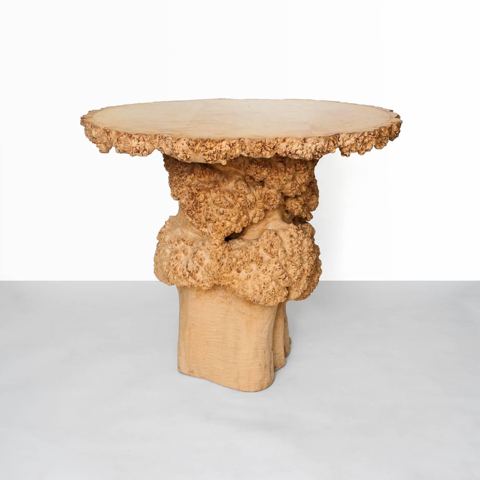 A Scandinavian modern side or occasional table made for a tree (probably beech) trunk. The table features large sections of burl on it's column form and along the rim of the table's top. The top is hinged and when open the maker's initials and the