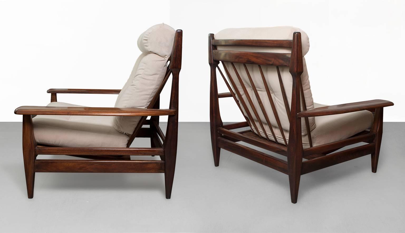 Large pair of Mid-Century carved solid rosewood lounge chairs from Brazil. The chairs balance bold sculpted shapes with lighter structural elements. Lightly restored, new upholstery in excellent condition.
 
Measures: Height 36