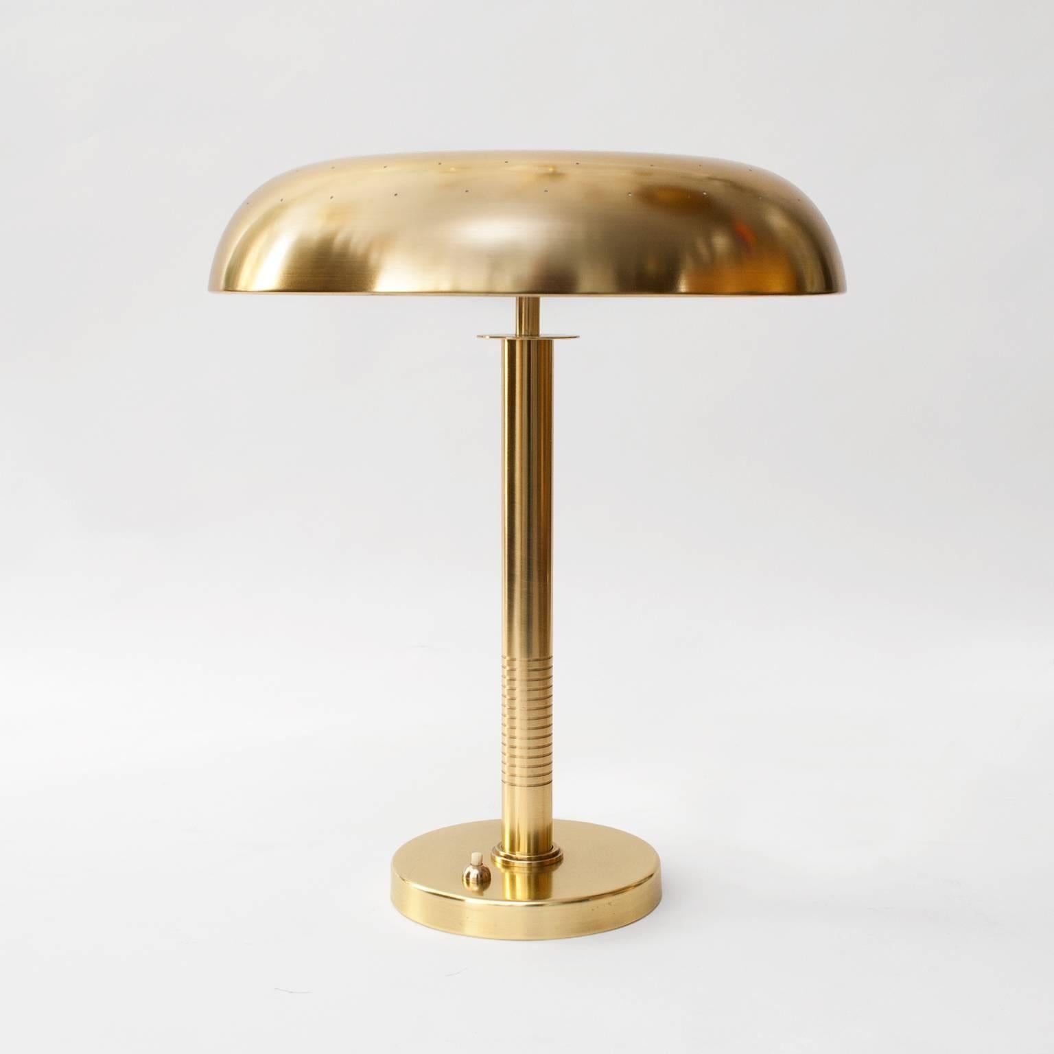 Scandinavian modern table / desk lamp by Bertil Brisborg for Bohlmarks,  Sweden, circa 1950. Newly restored polished an lacquered brass, newly wired with 2 standard base sockets for use in the USA. Impressed manufacturer's mark to underside. Shade