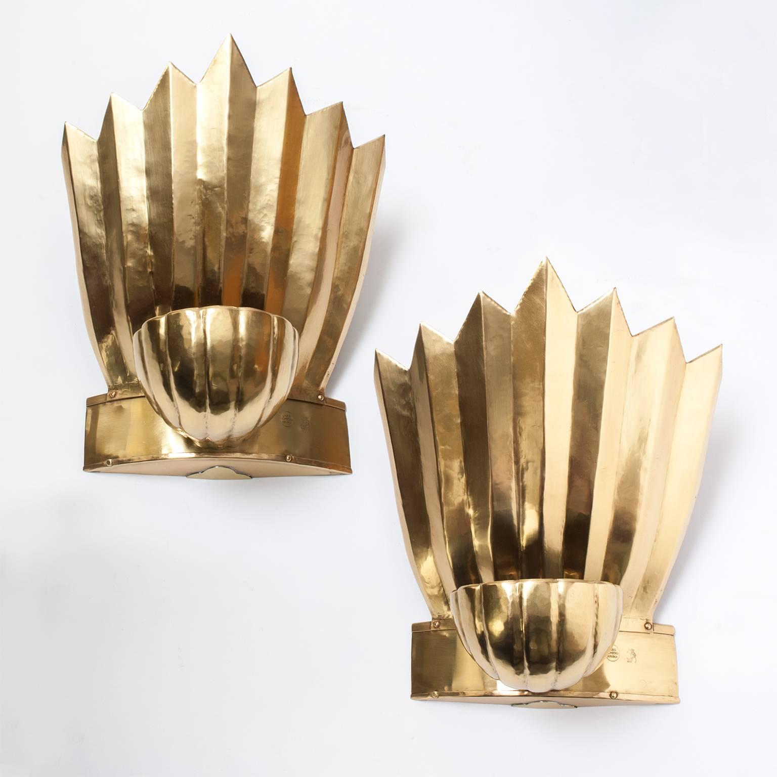 Pair of Scandinavian Modern, Swedish Grace / Art Deco large polished brass sconces designed by Lars Holmstrom for Arvika Konsthantverk (mark impressed), The sconces have two light sources one inside the shell shaped shade which reflects light to the