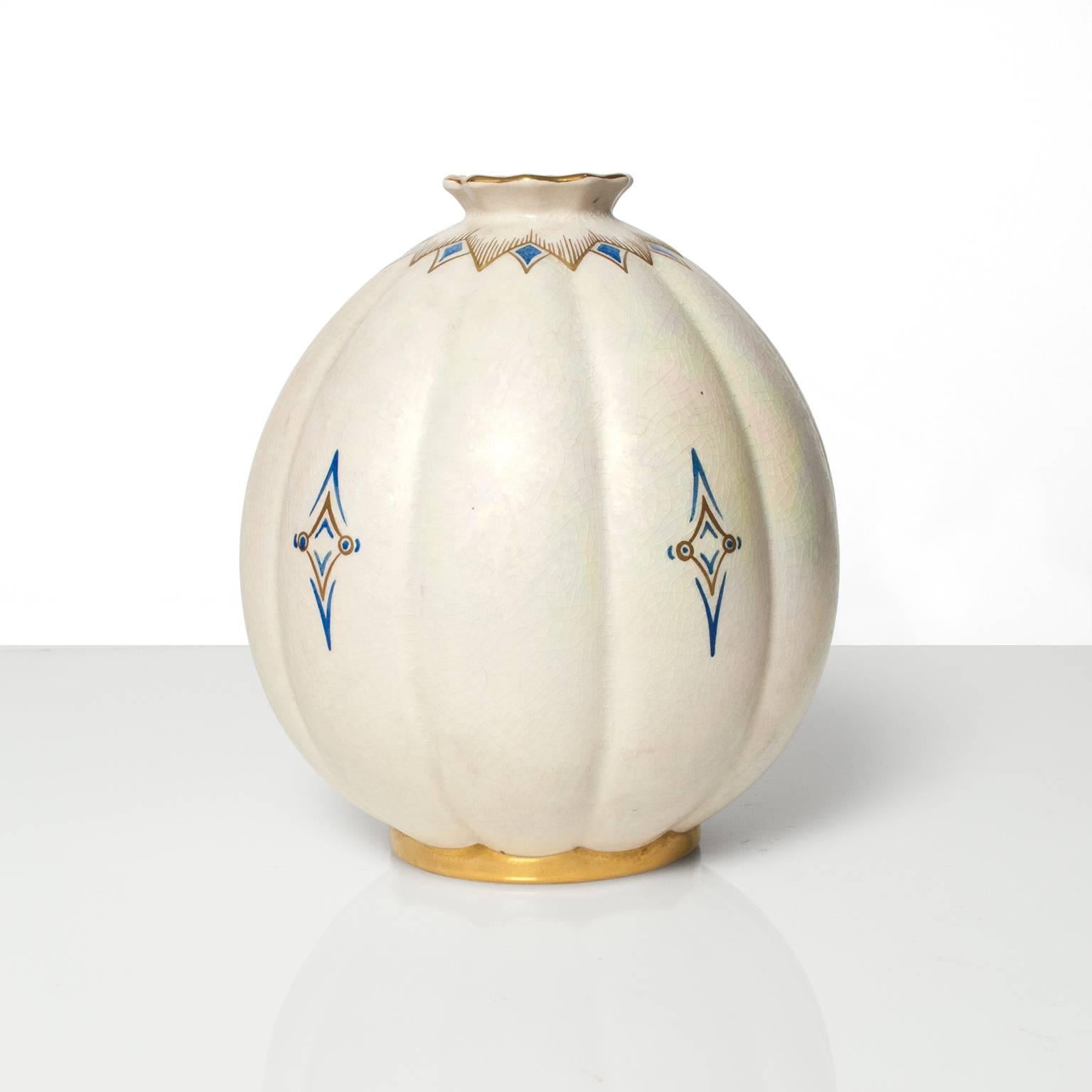 Scandinavian Modern, Swedish Art Deco hand decorated ceramic vase in white pearl uster glaze with details in gold and blue, from Gustavsberg. Designed and signed by Josef Ekberg, 1936. Height: 9", Diameter: 7.75".