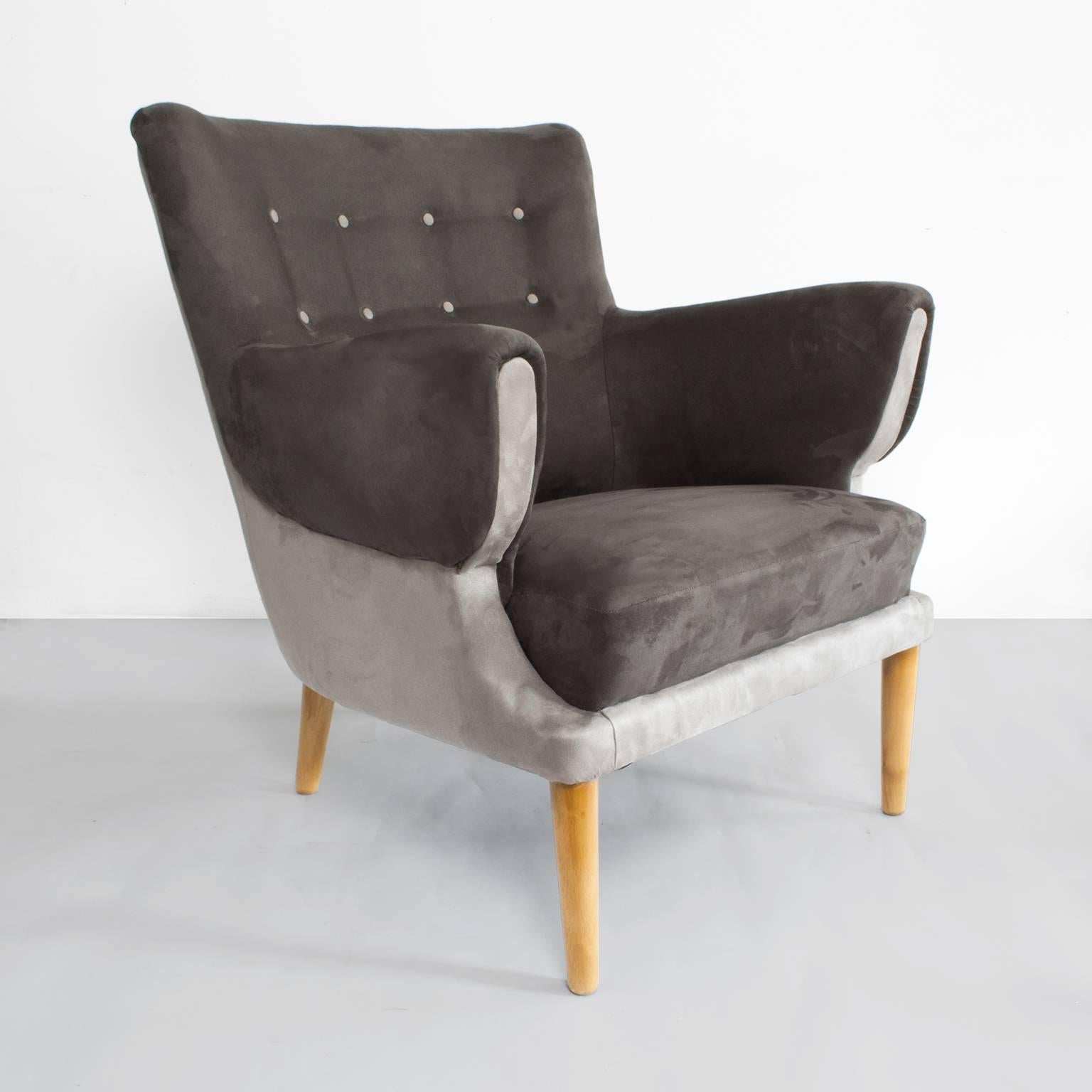 Scandinavian Modern (Danish) lounge chair newly restored and re-upholstered in two shades of gray ultra-suede fabric. The chair has contrasting tufted buttons on the backrest and polished solid beechwood dowel legs. 
Measures: Height 31.5