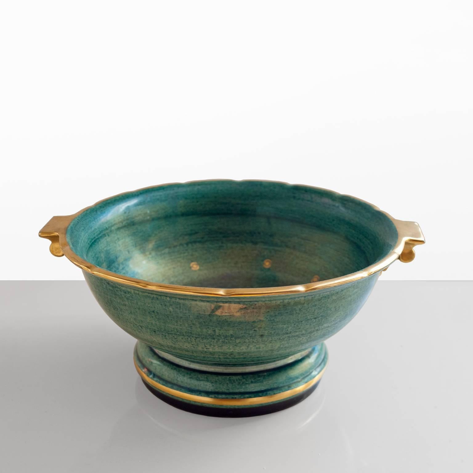 Scandinavian Modern ceramic footed bowl by Josef Ekberg in luster glaze with hand decorated details in gold. Made at Gustavsberg, signed and dated.

Measures: Diameter 11.5" x height 5".