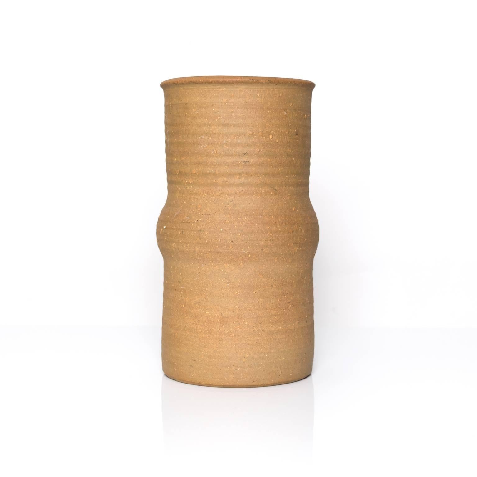 A tall Scandinavian Modern ceramic studio vase by designer Signe Persson-Melin. The exterior is unglazed in a clay often referred to as 