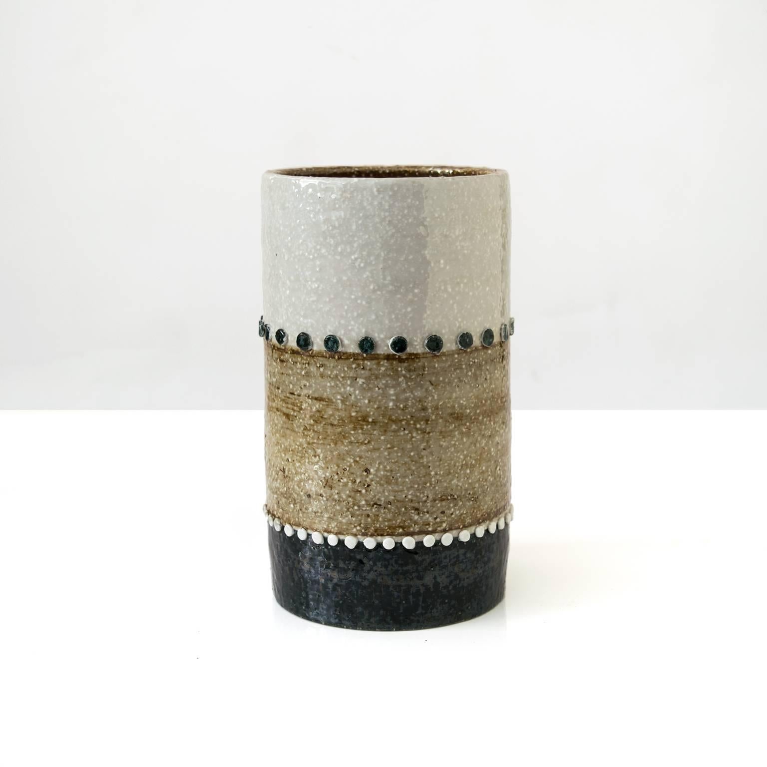 A tall Scandinavian Modern Mid-Century ceramic studio vase with raised decorative elements and finished in neutral colored glazes, by designer Sylvia Leuchovius for Rorstrand, Sweden.

Measures: H 8.75", D 5".