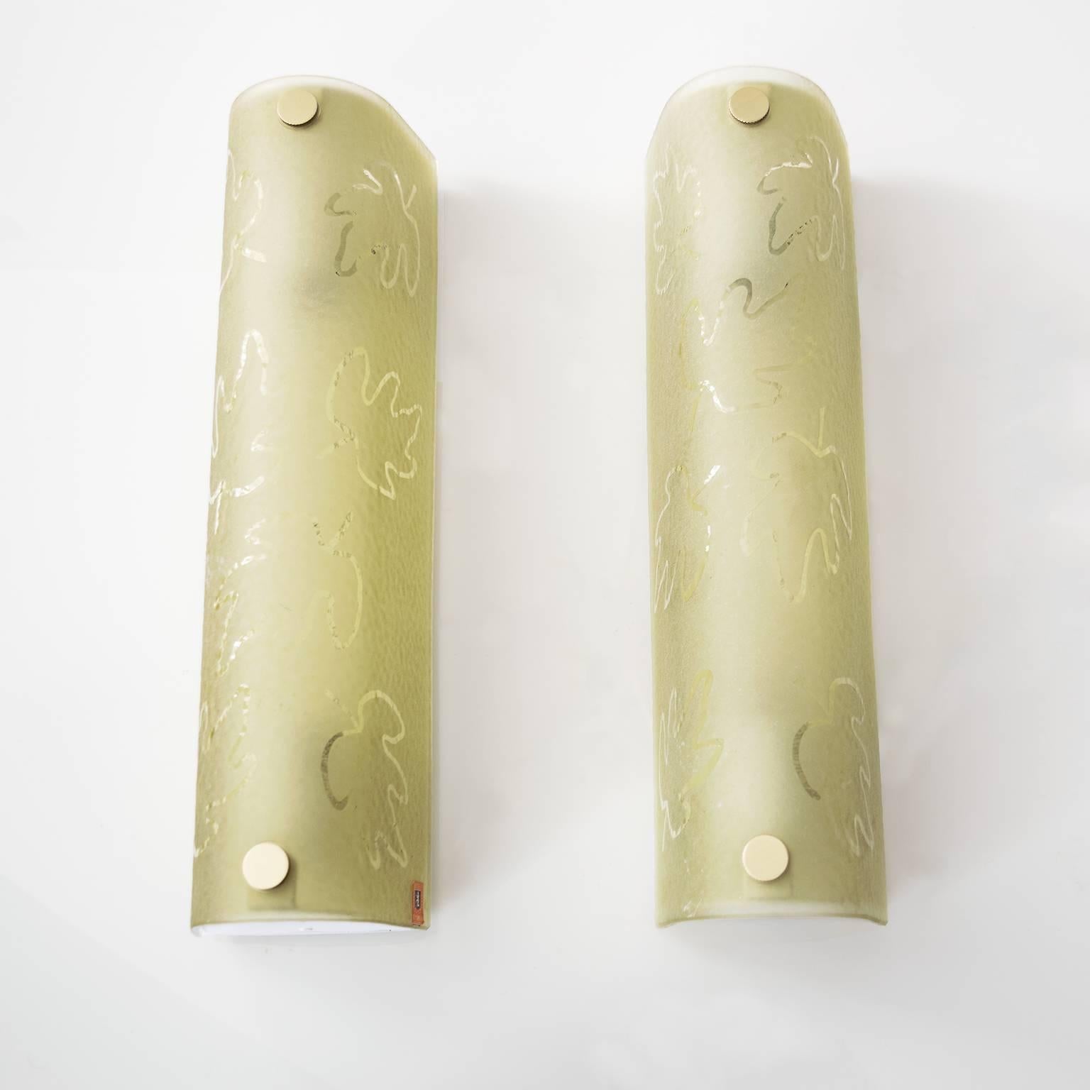 Pair of Scandinavian Modern bowed shaped etched glass sconces with leaf motif. The surface has a combination of acid and hand etched finish. Each sconce has two standard Edison sockets, newly rewired for use in the USA. Mounts are newly painted and