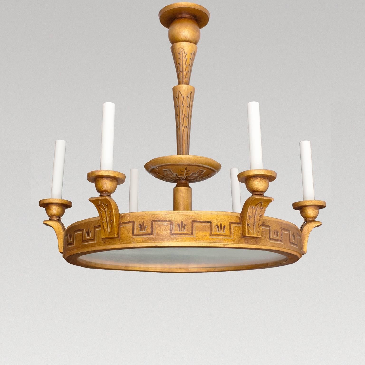 Unique Swedish Art Deco ring form chandelier with six arms. There are three additional sockets within the ring which illuminate a sandblasted glass plate diffuser. The chandelier features a hand-painted Meander motif in trompe l'oeil, The stem, arms