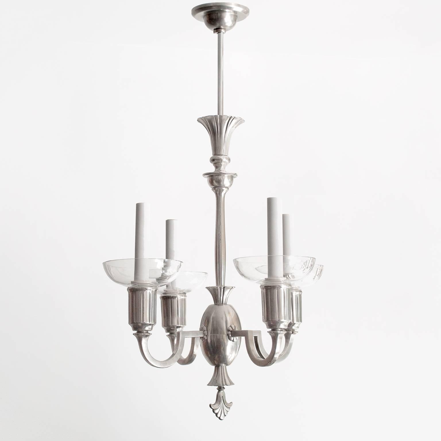 Delicate Swedish Art Deco 4-arm chandelier in polished and lacquered pewter. Each arm holds a candelabra socket, a sleeve and a crystal bobeche. A modern design which features many classical details. Newly electrified in excellent condition.