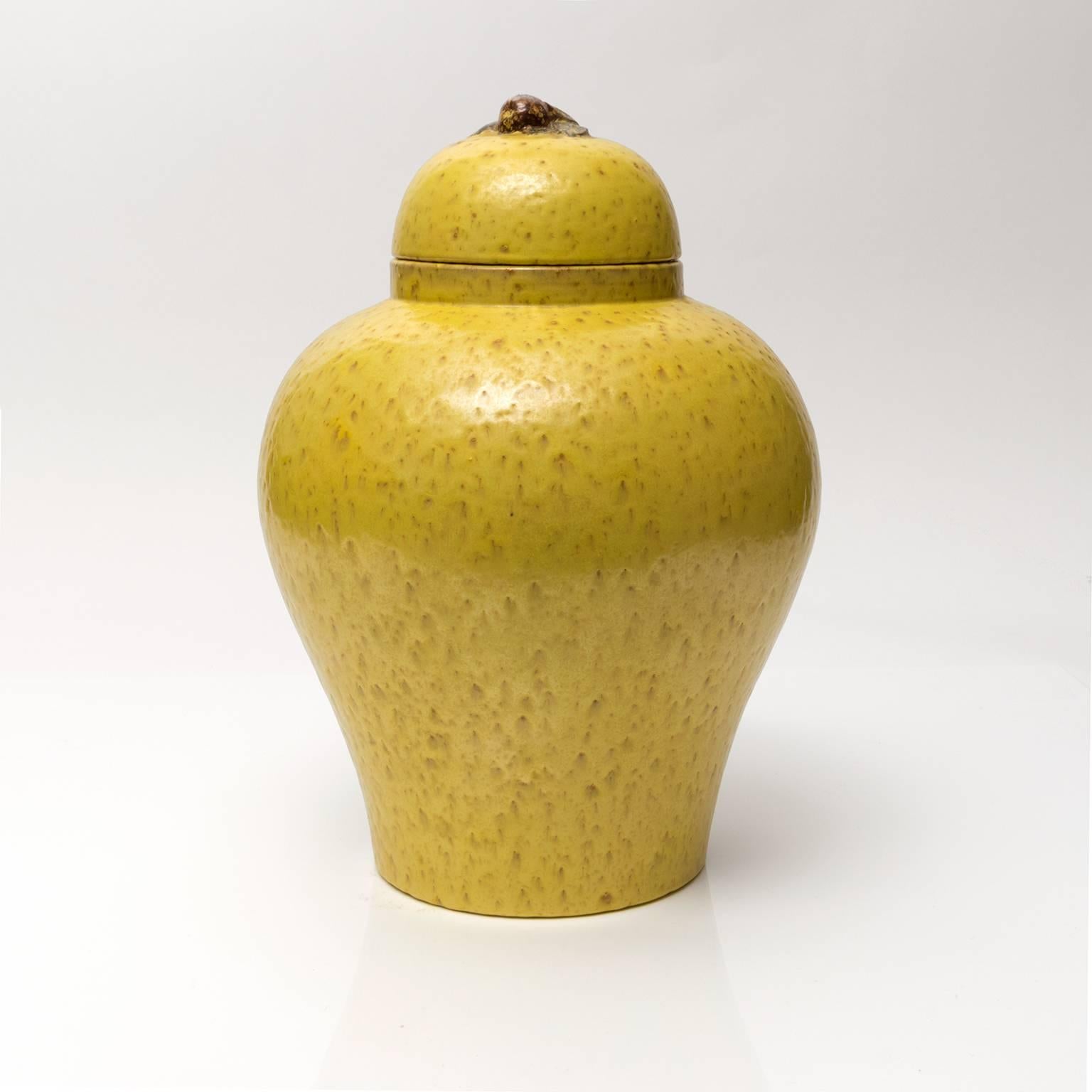 A large glazed ceramic jar with lid designed by Jerk Werkmaster for Nittsjo, Sweden, 1930s. The lid is decorated with a piece of fruit and a few leaves. Dimensions: H 7.5" x D 5", H 6" x Dimensions: H 13.5" x Diameter: 9".